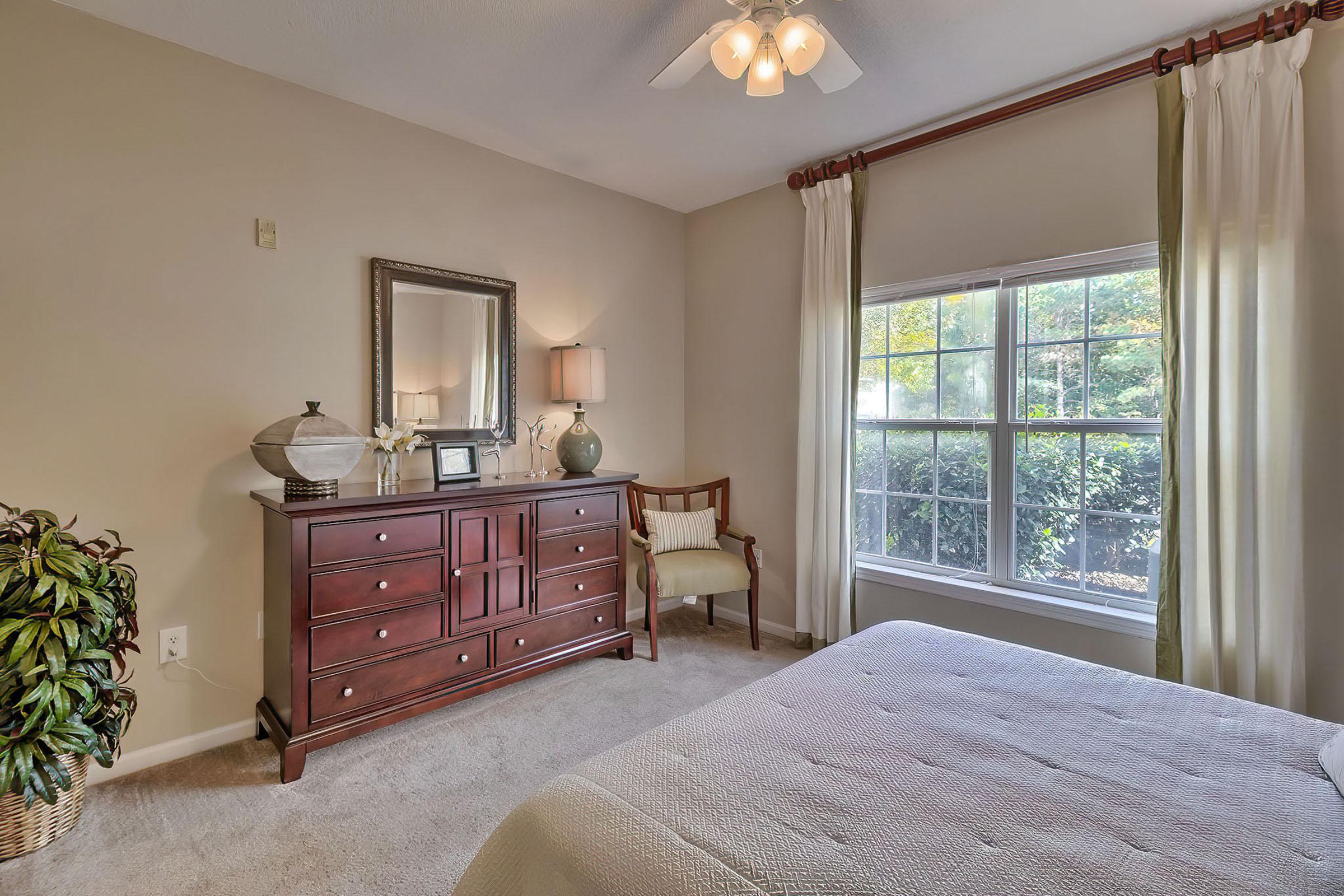 a bedroom with a bed and window in a room