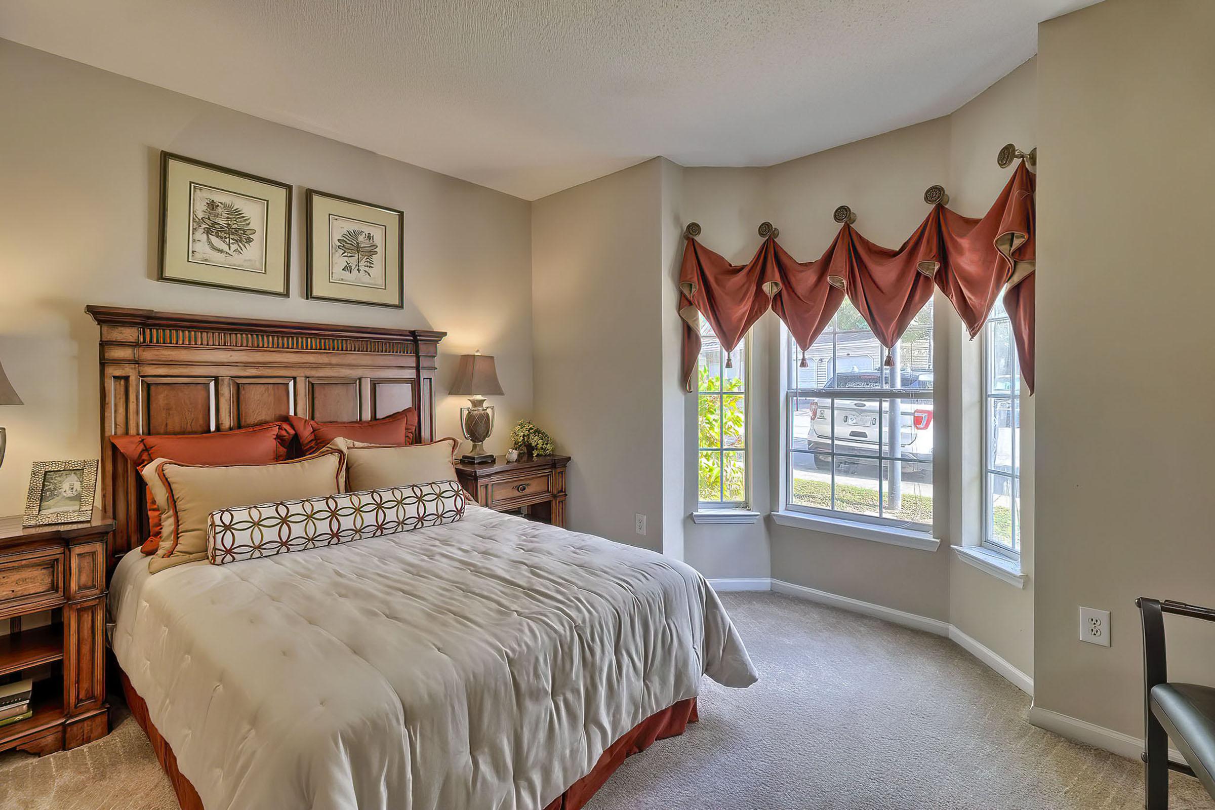 a bedroom with a large bed in a room