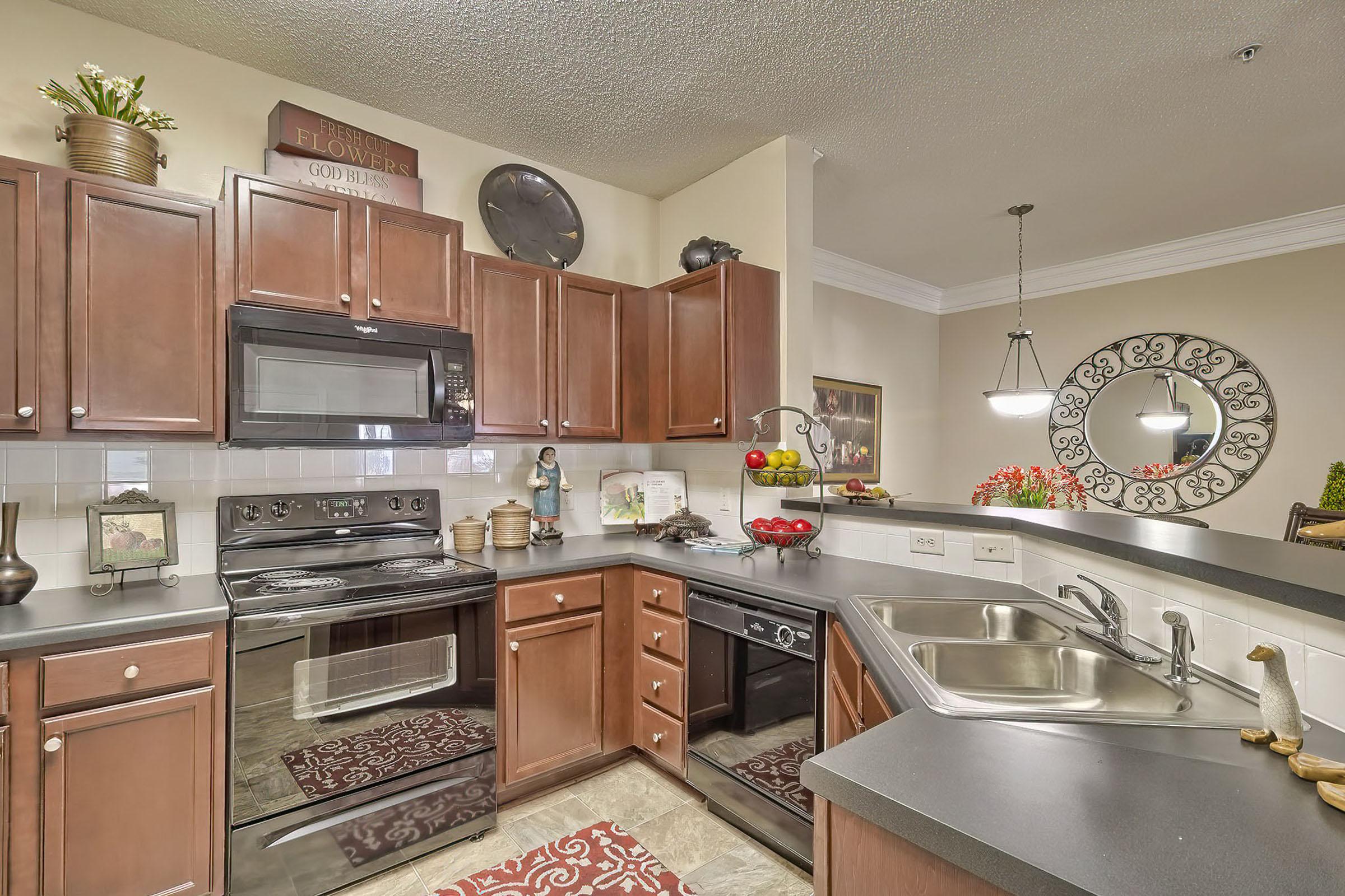 a modern kitchen with stainless steel appliances and wooden cabinets