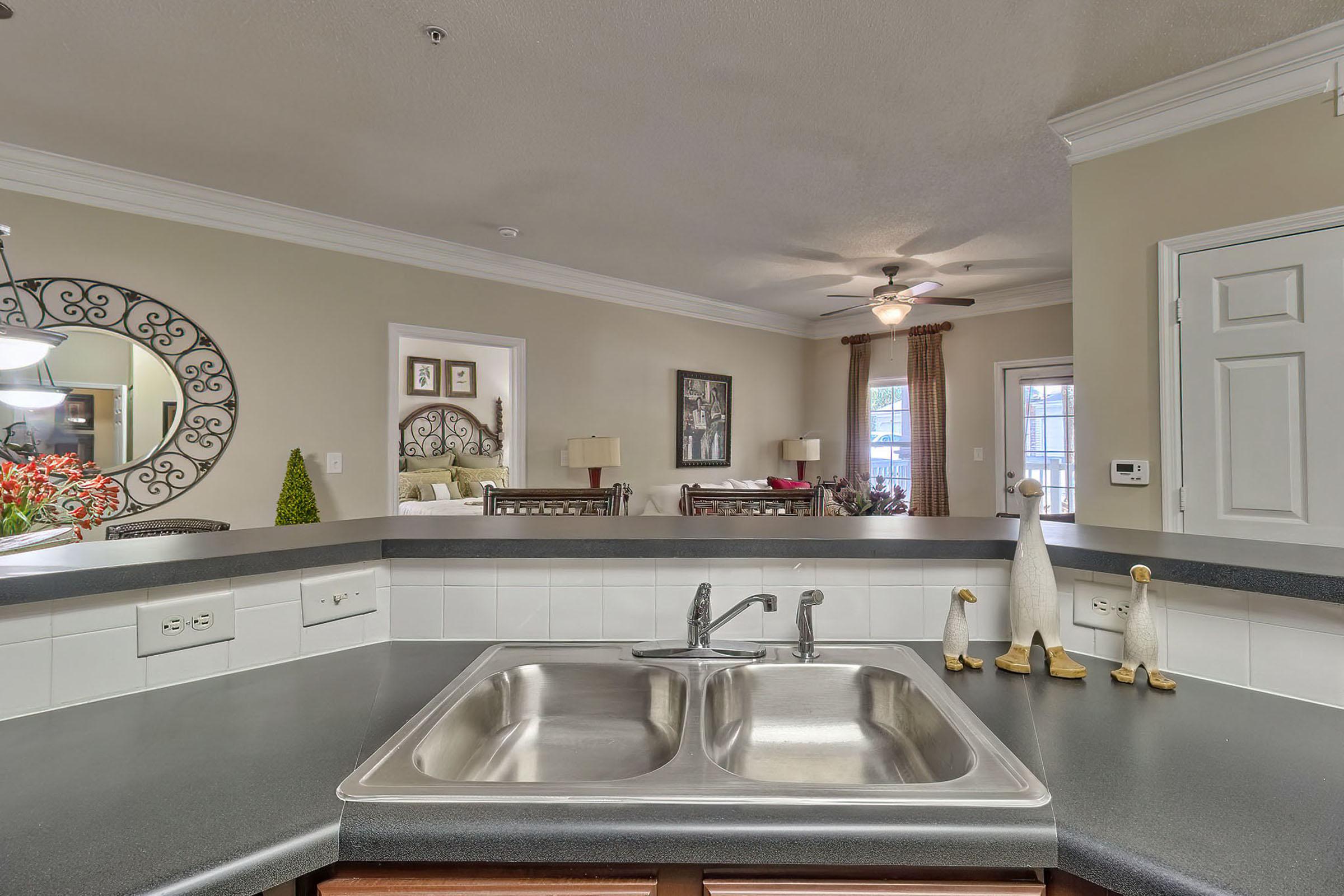 a kitchen with a sink and a mirror