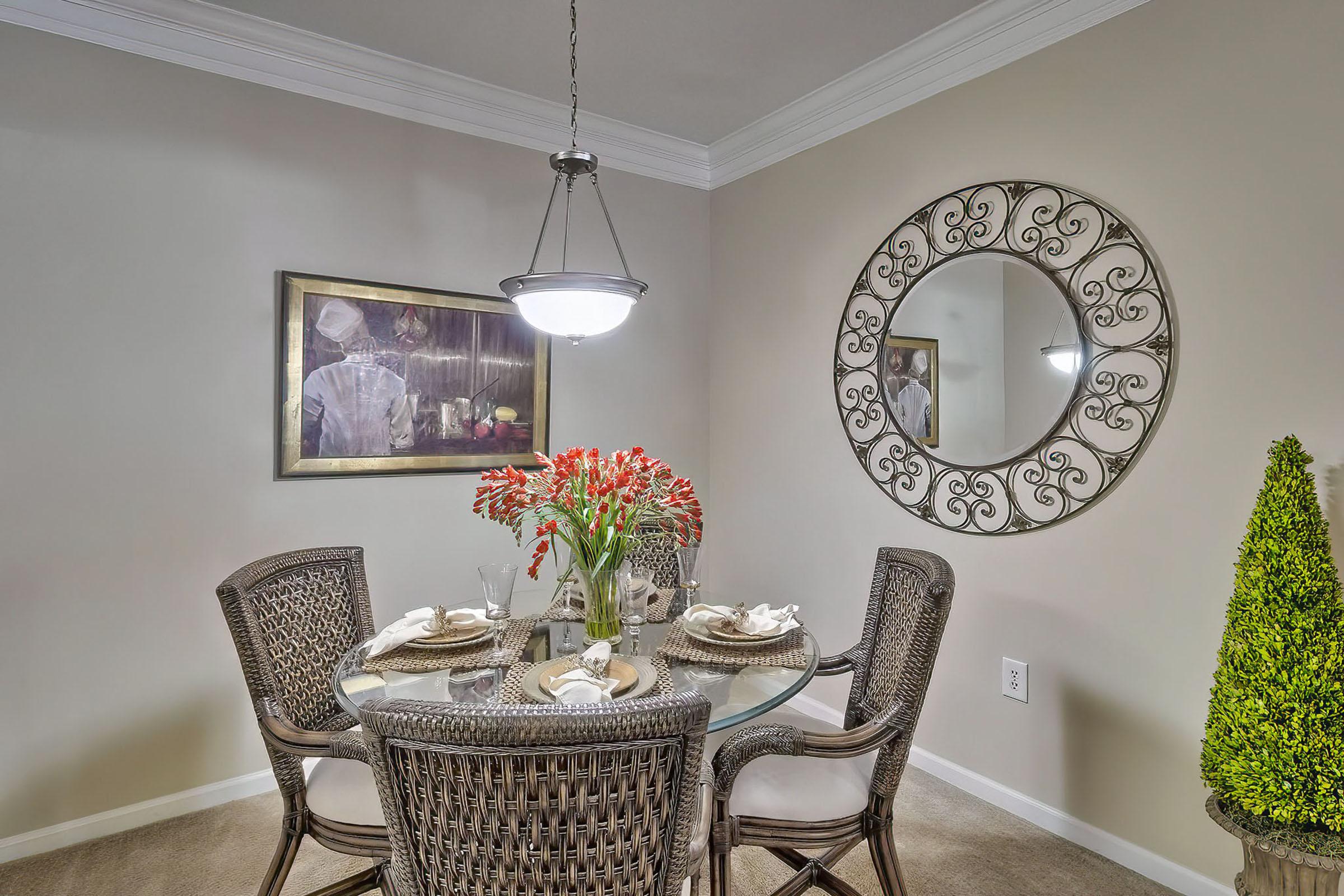 a room filled with furniture and vase of flowers on a table