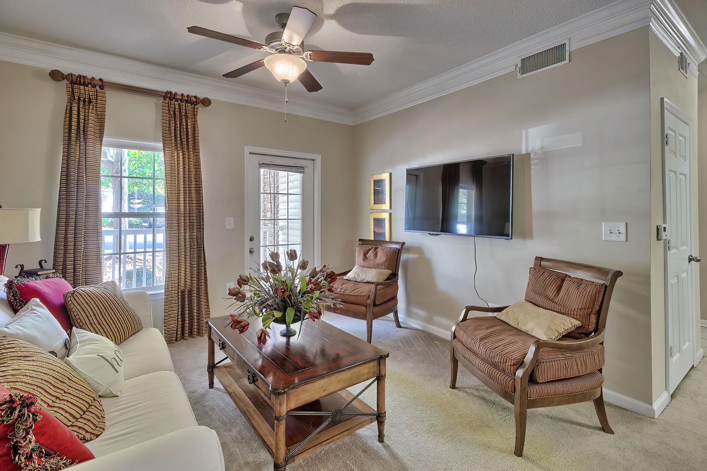 a living room filled with furniture and a large window