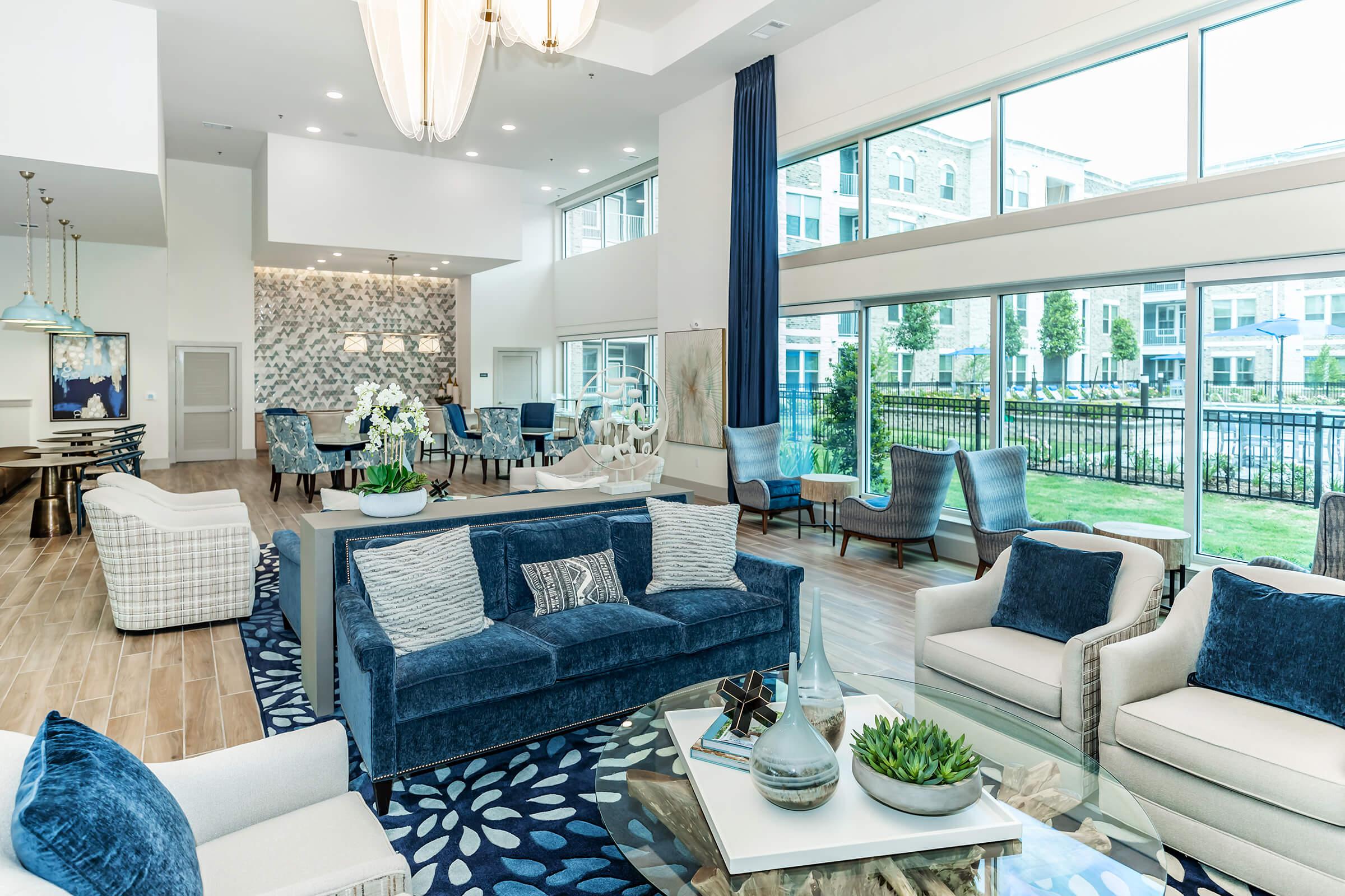 a living room filled with furniture and a large window