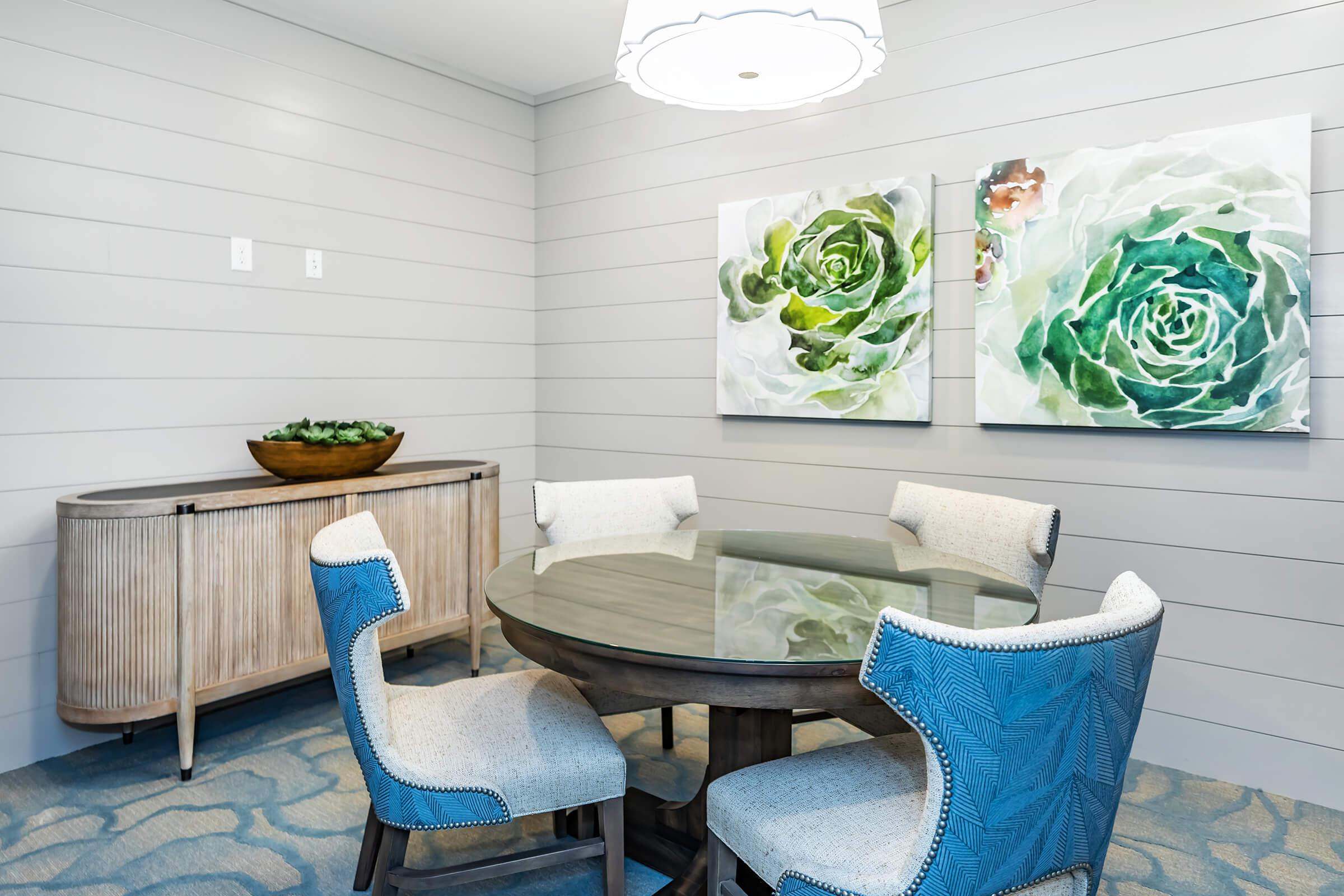 a table topped with a blue chair