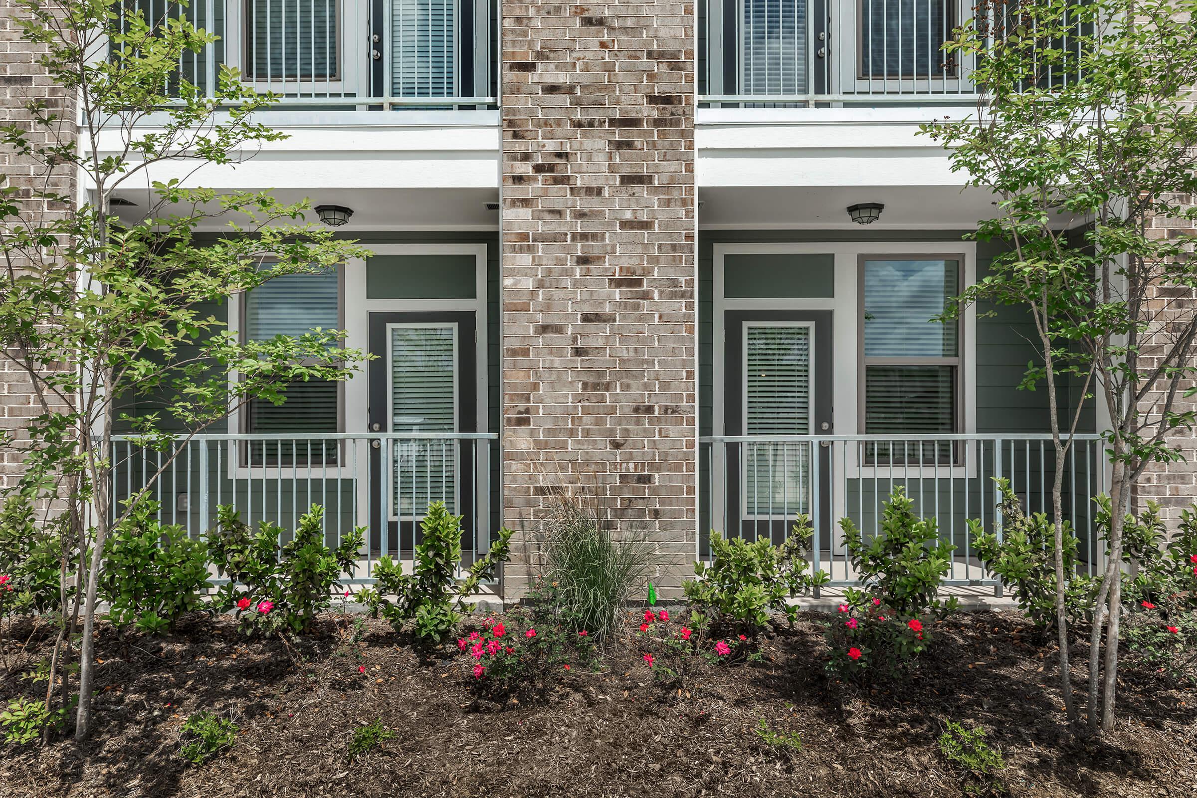 a house with bushes in front of a building