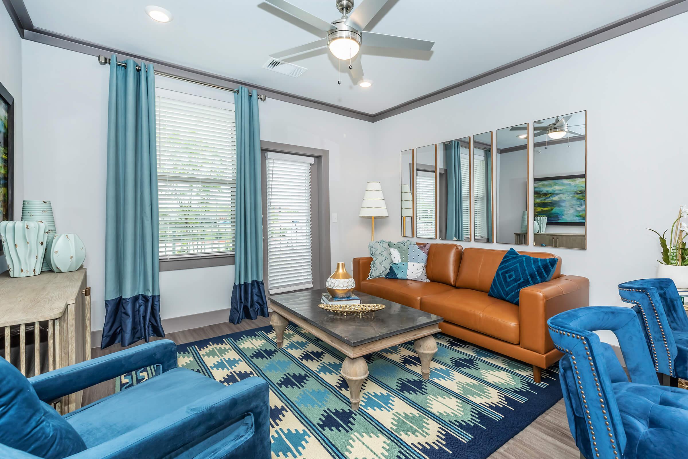 a living room filled with furniture and a large window