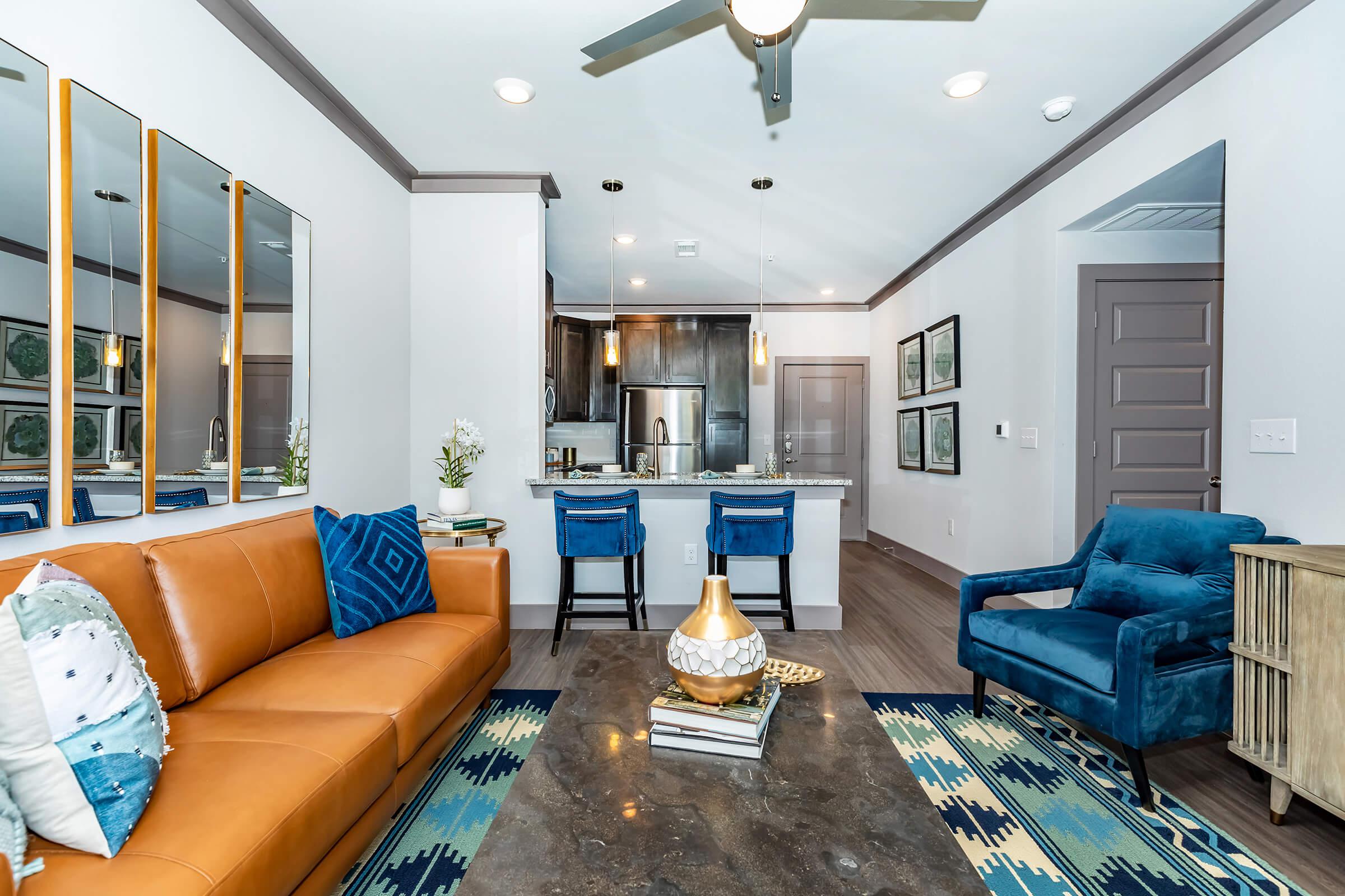 a living room filled with furniture and a large window