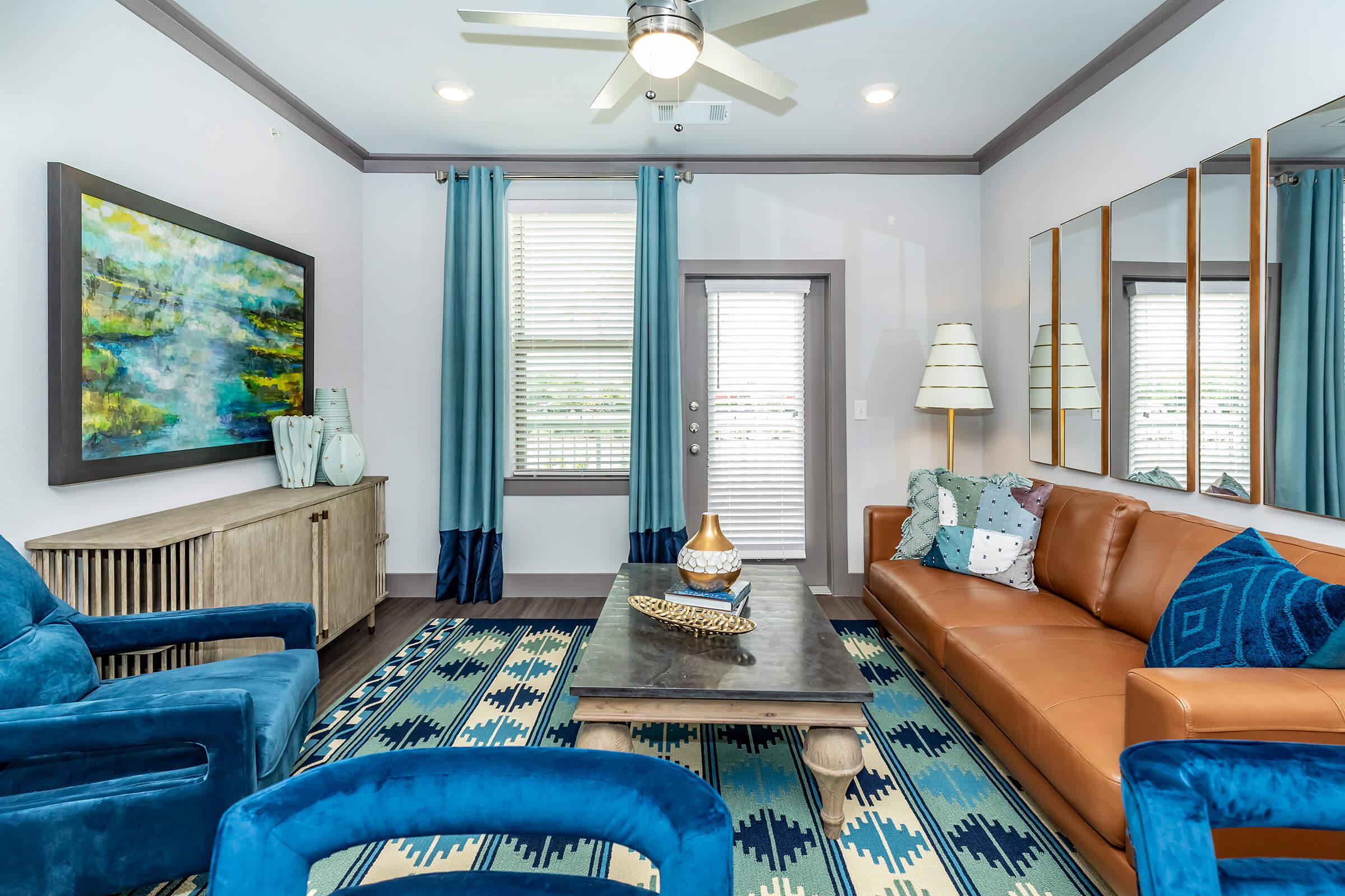 a living room filled with furniture and a large window