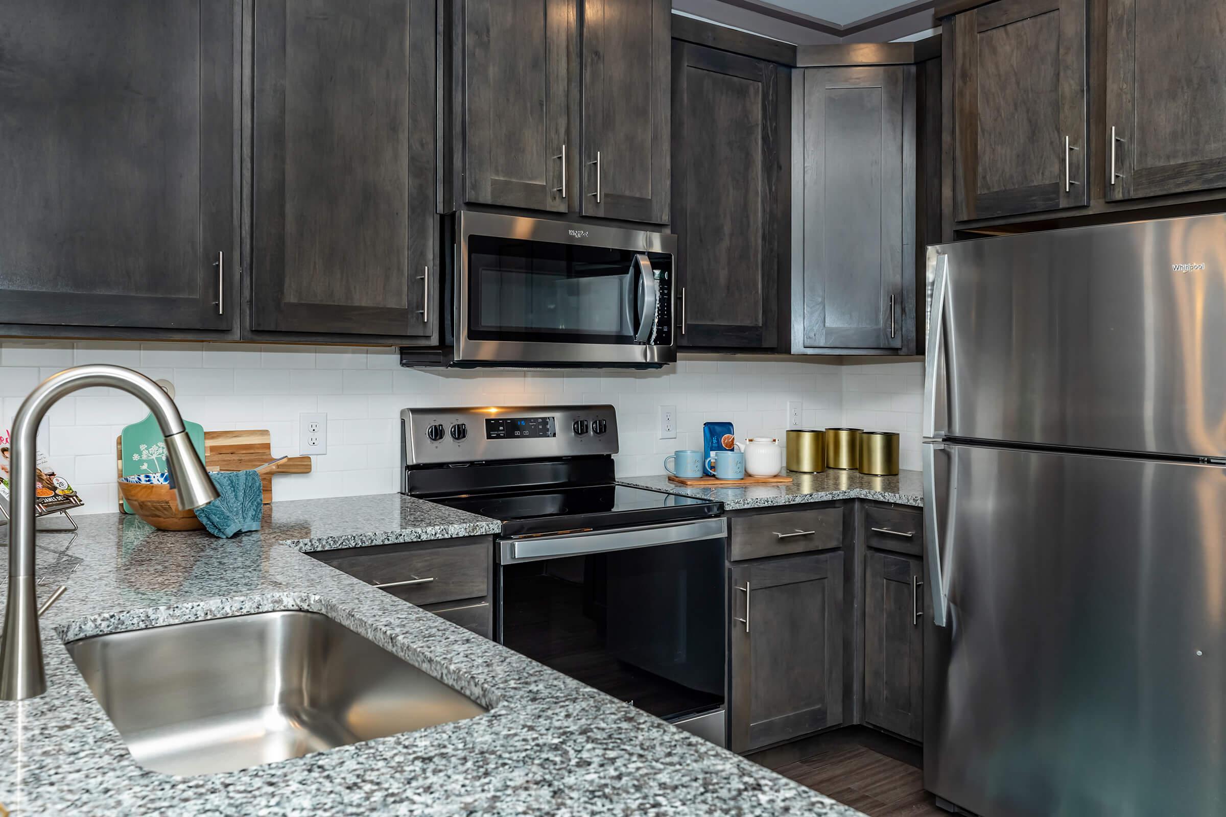 a kitchen with stainless steel appliances and wooden cabinets