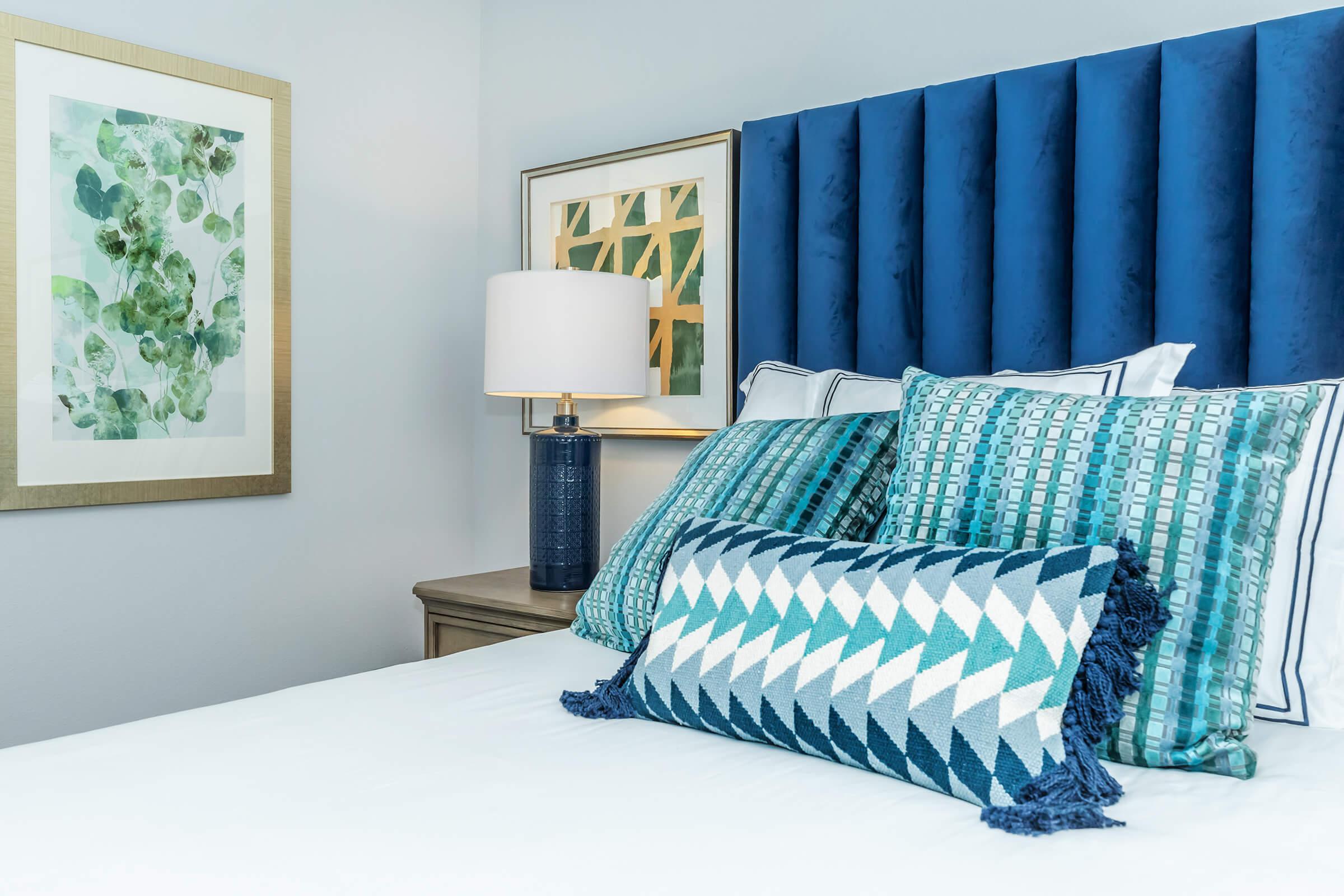 a bedroom with a blue pillow on a bed