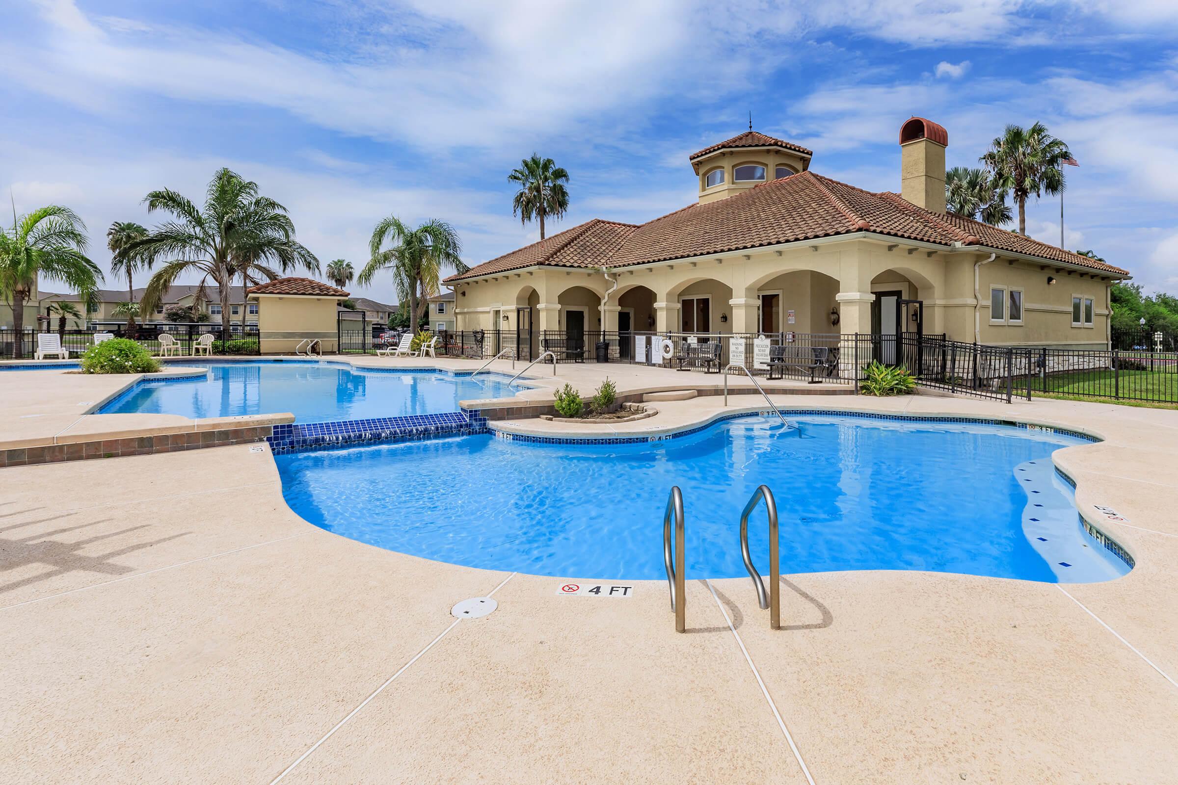 a blue pool of water in front of a building