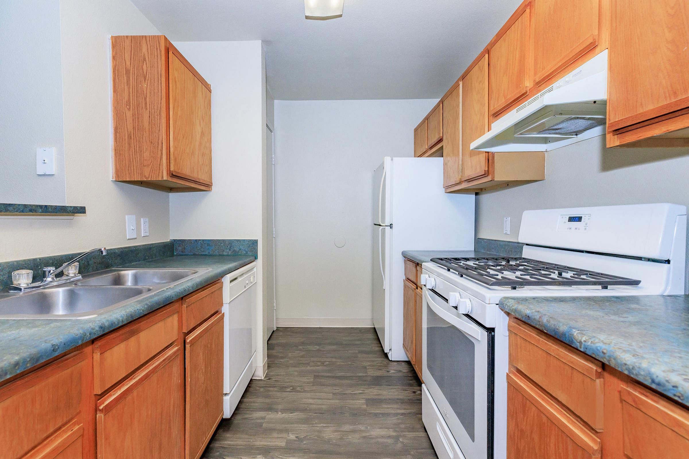 a kitchen with a stove sink and refrigerator