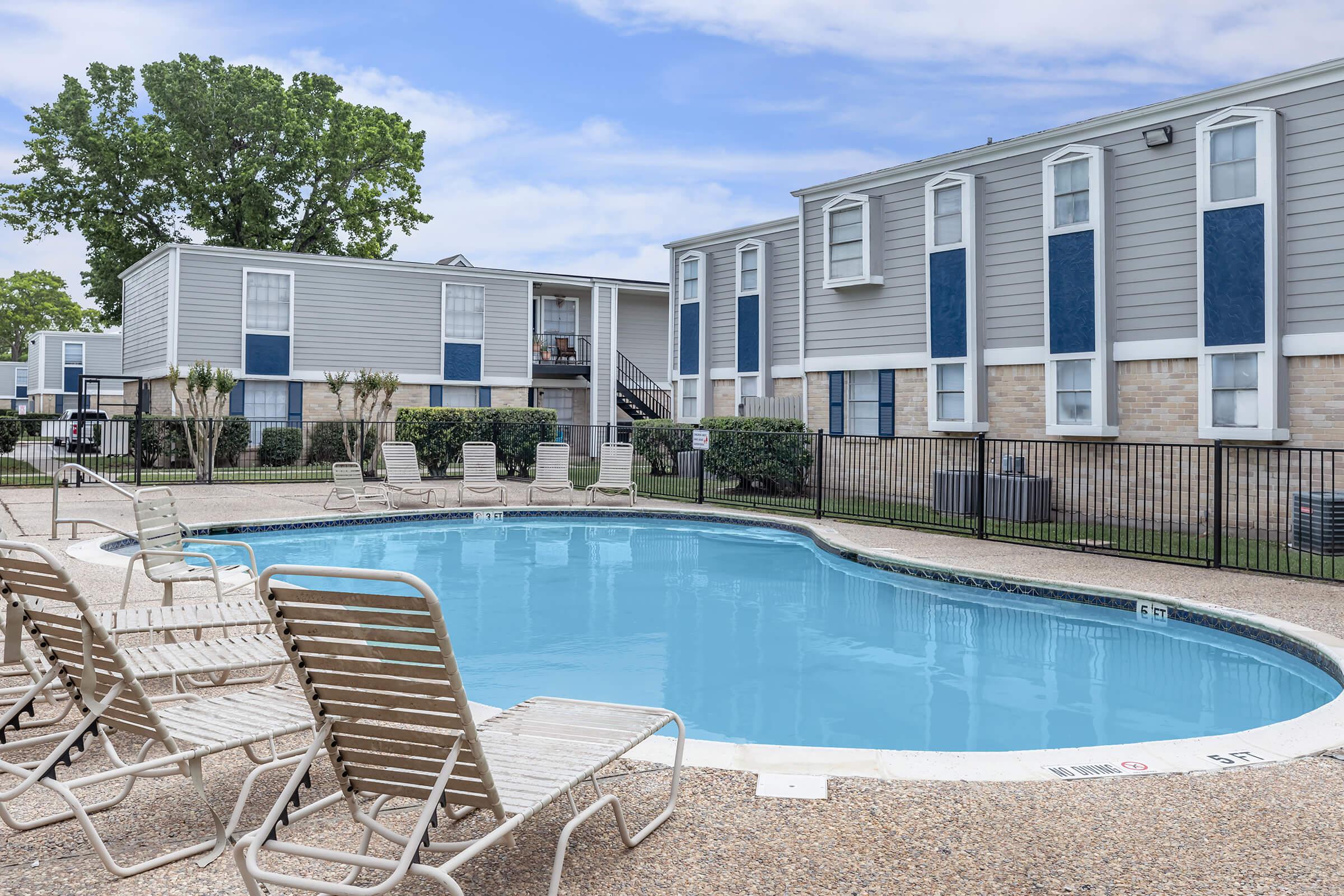 a house with a pool in front of a building