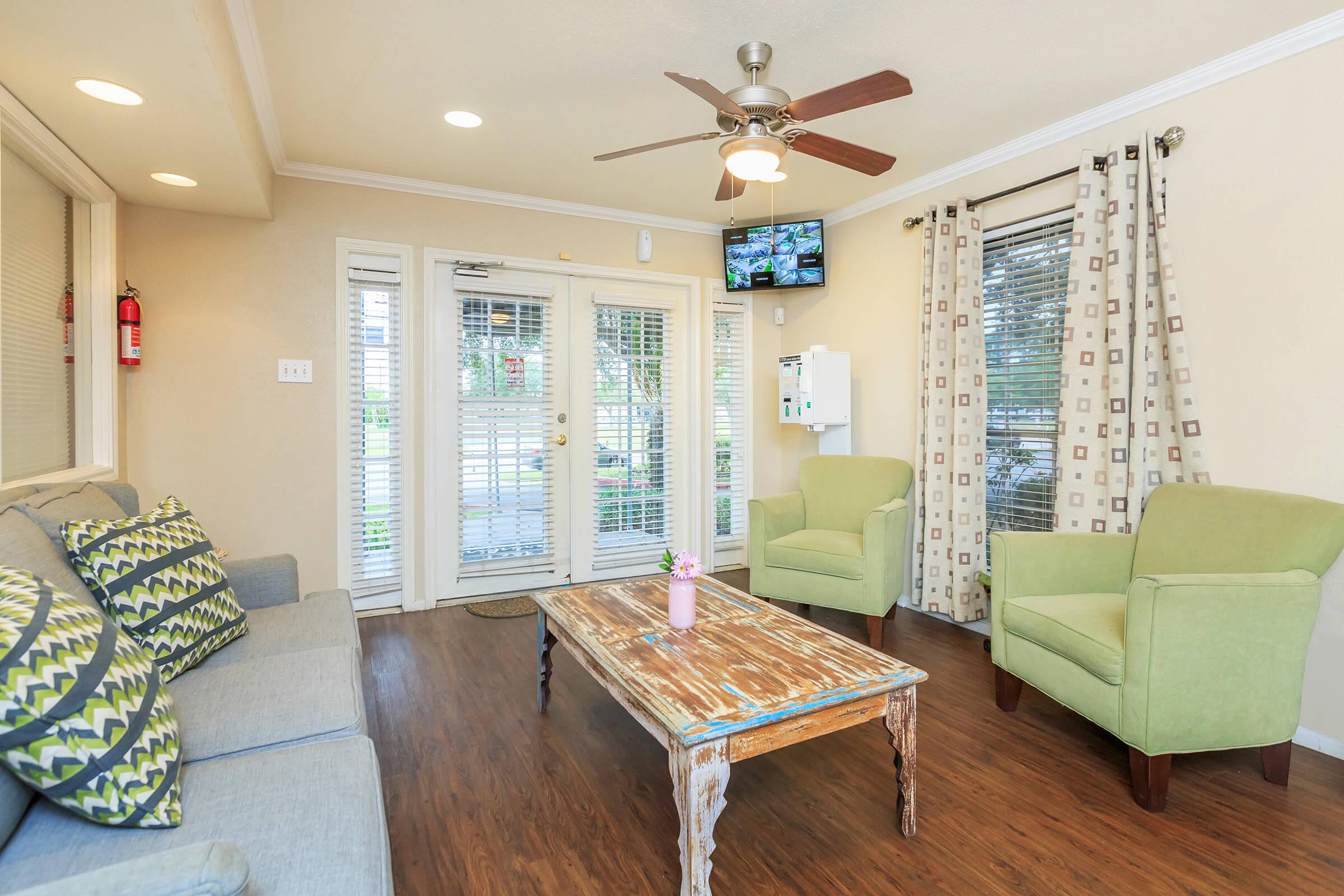 a living room filled with furniture and a large window