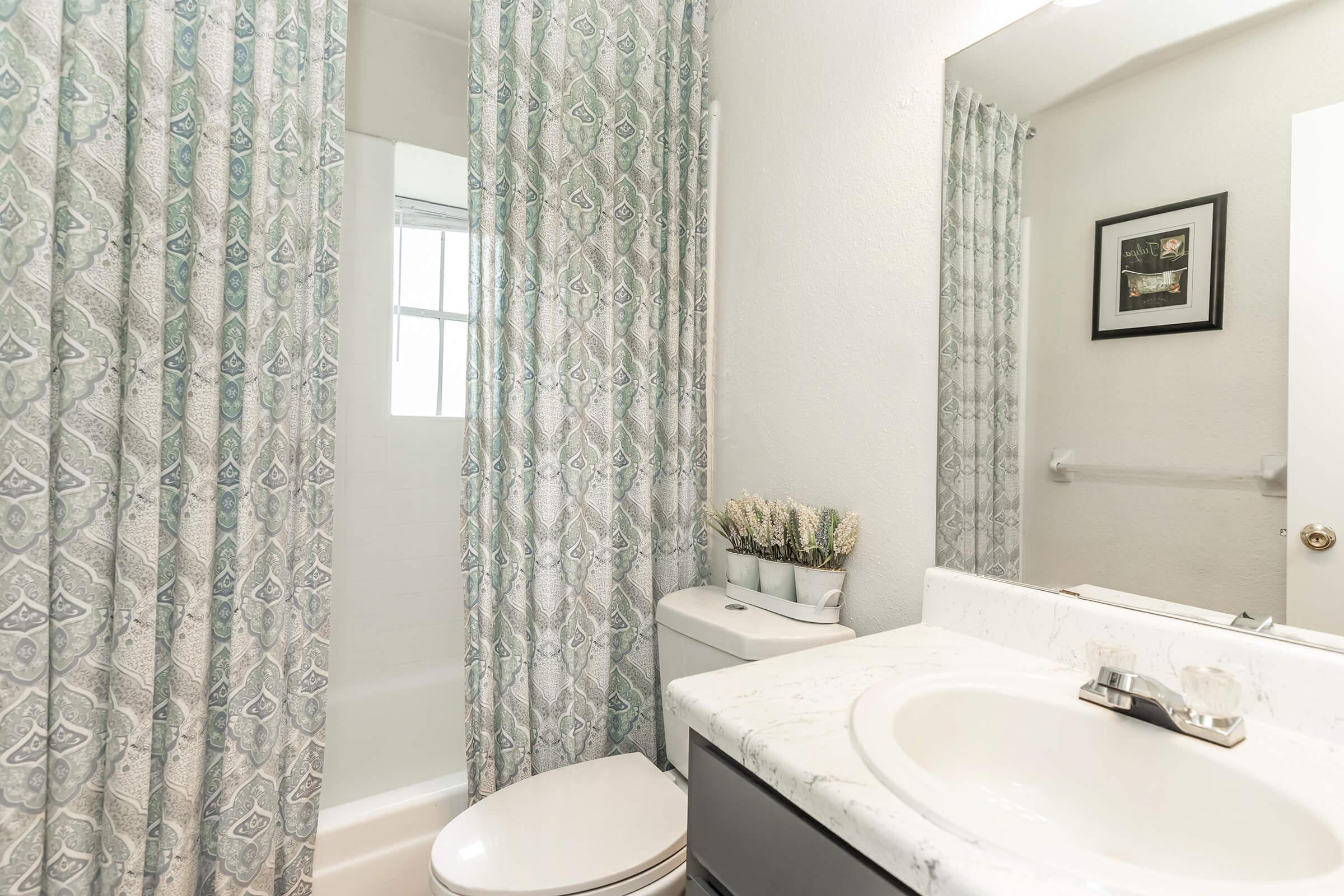 a shower curtain next to a sink