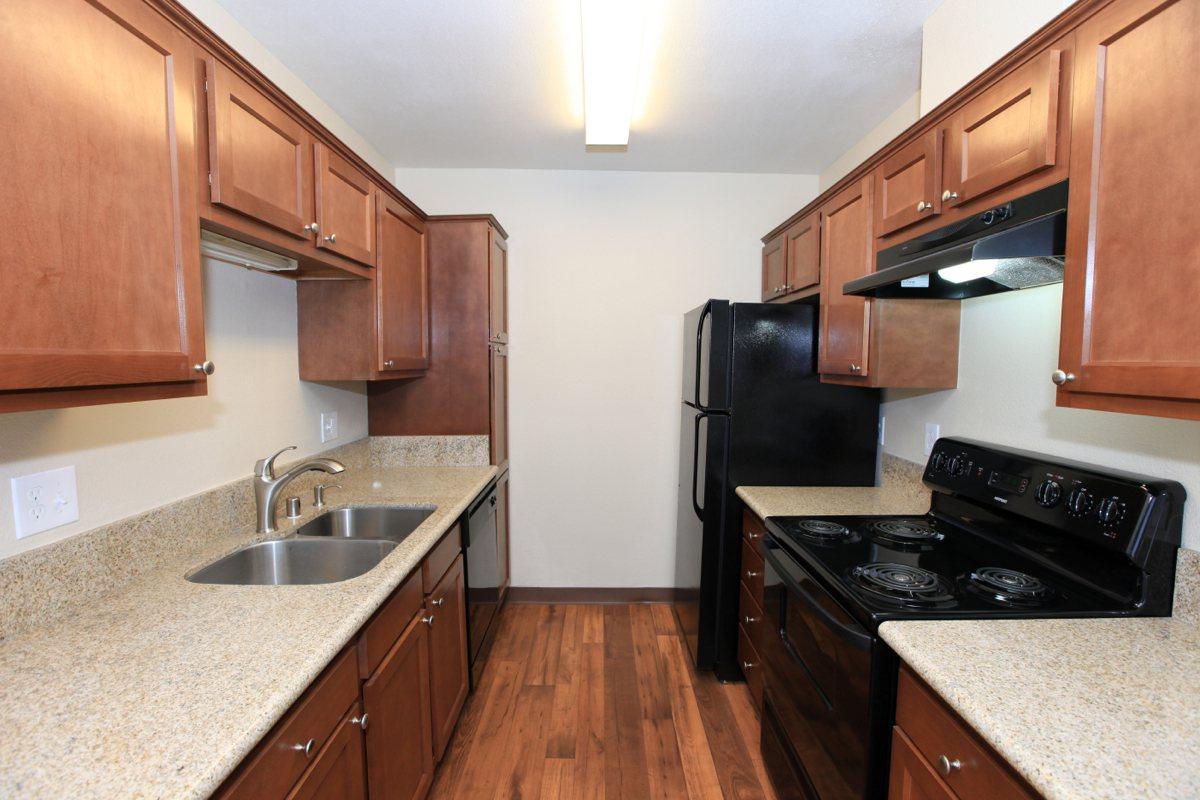 a kitchen with stainless steel appliances and wooden cabinets