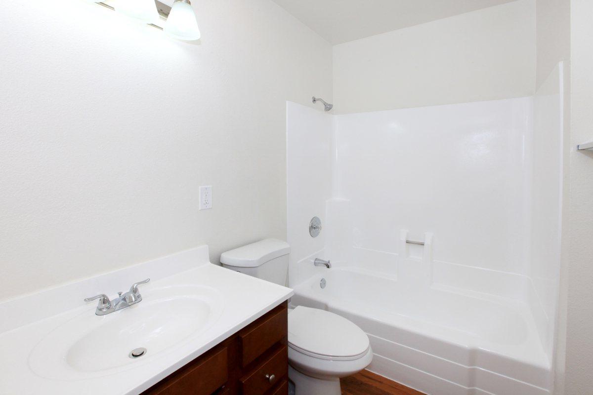 a white sink sitting next to a shower