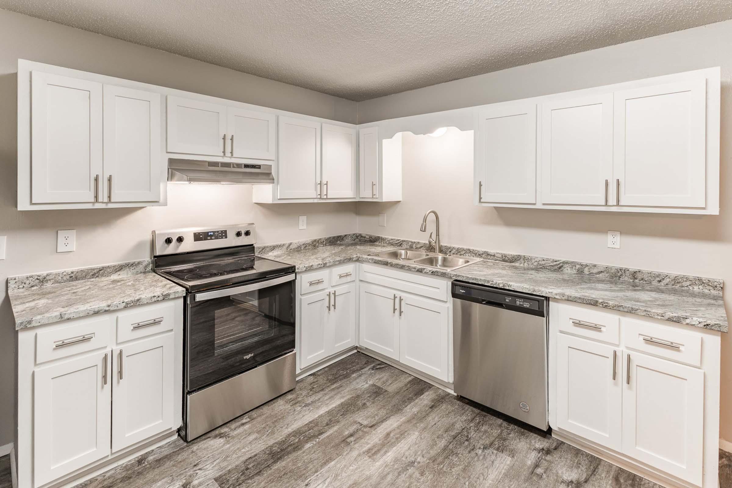 a kitchen with a stove sink and refrigerator