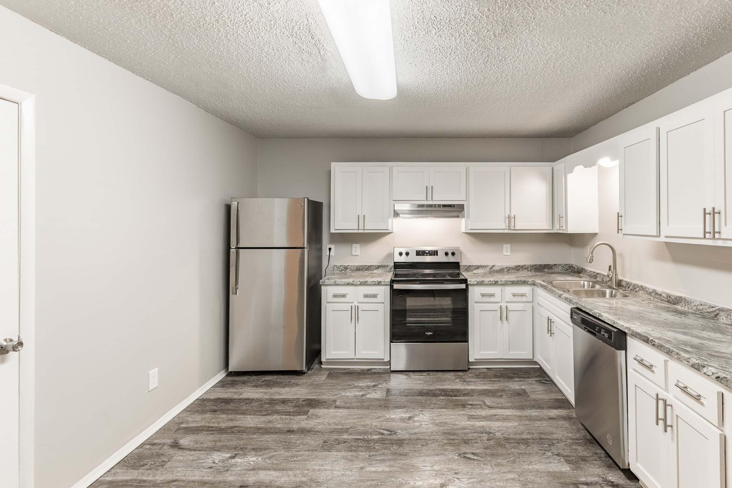 a kitchen with a stove and a refrigerator