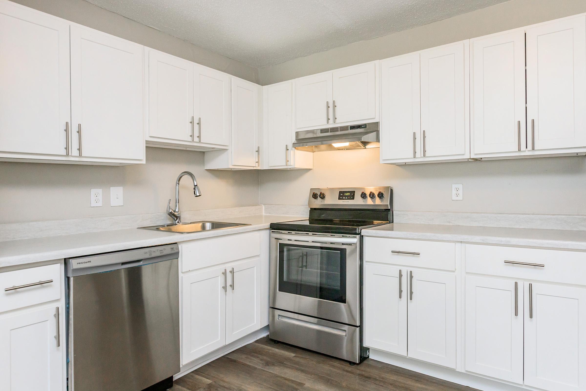 a kitchen with a stove sink and refrigerator