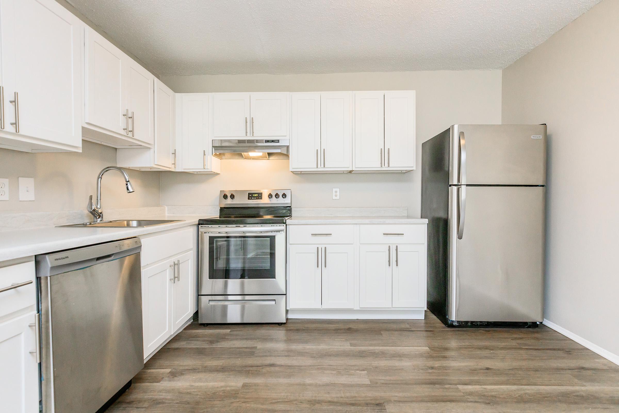 a kitchen with a stove sink and refrigerator