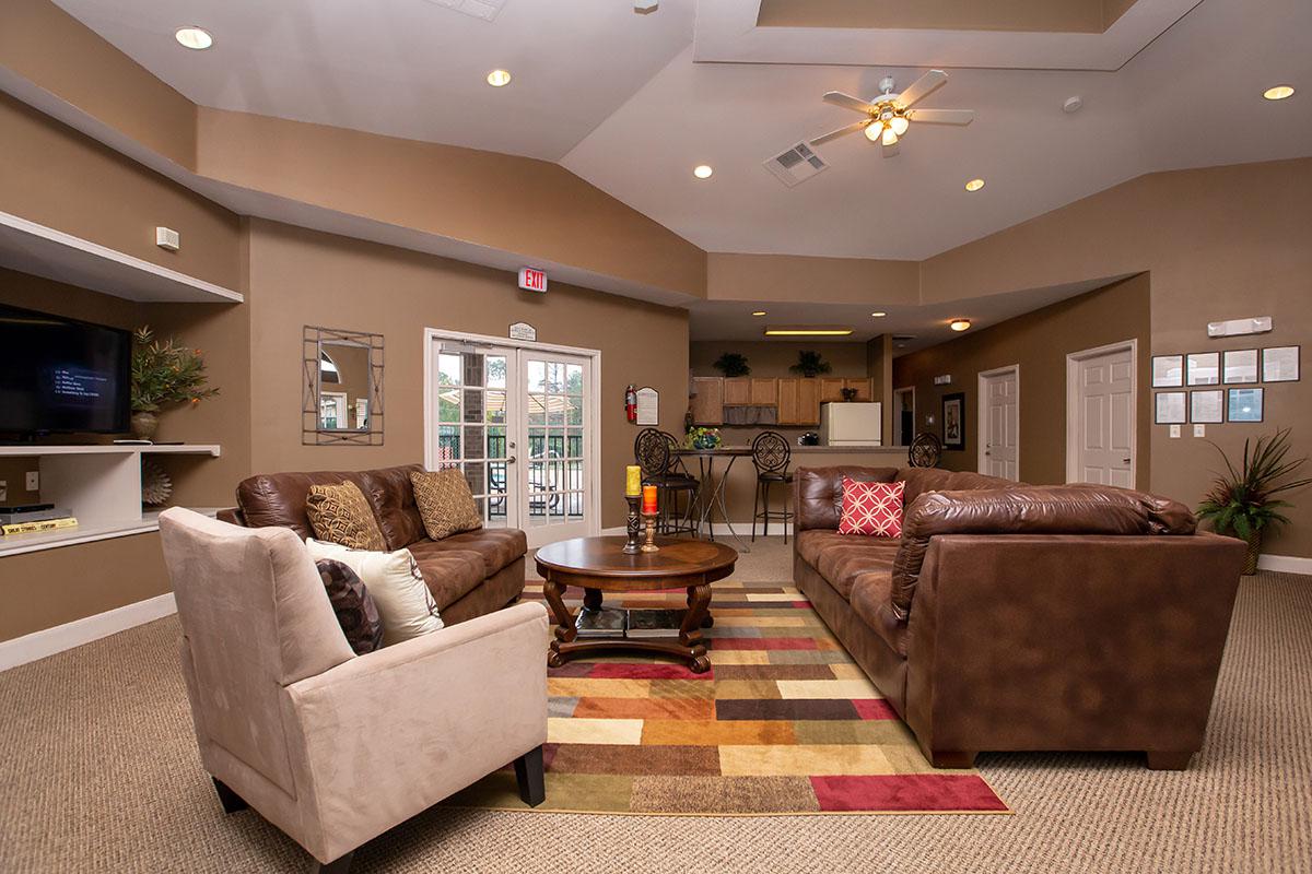 a living room filled with furniture and a flat screen tv