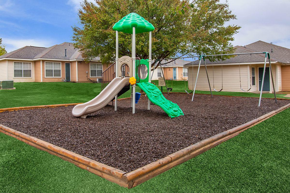 a green lawn in front of a house