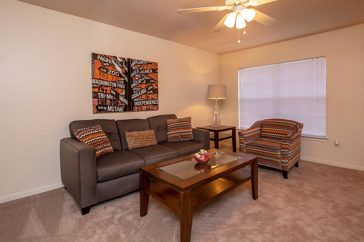 a living room filled with furniture and a table