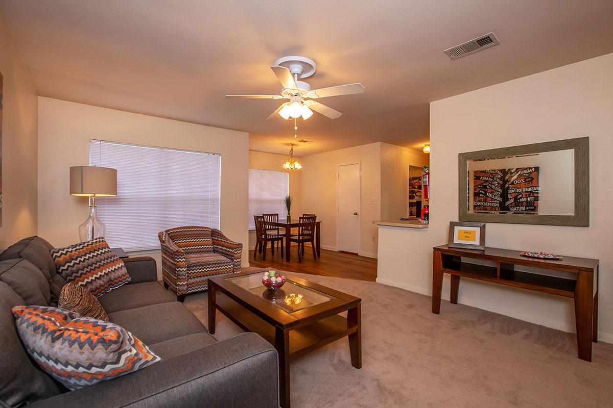 a living room filled with furniture and a flat screen tv