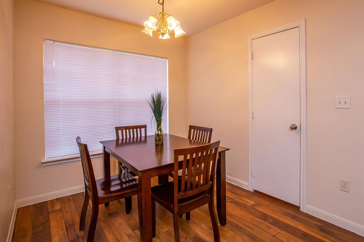 a dining room table in front of a window