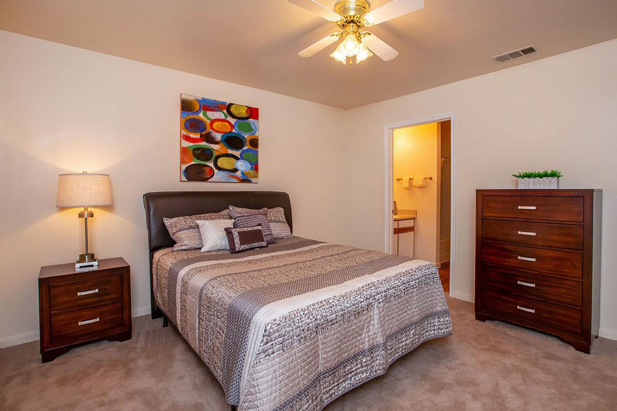 a bedroom with a bed and desk in a room