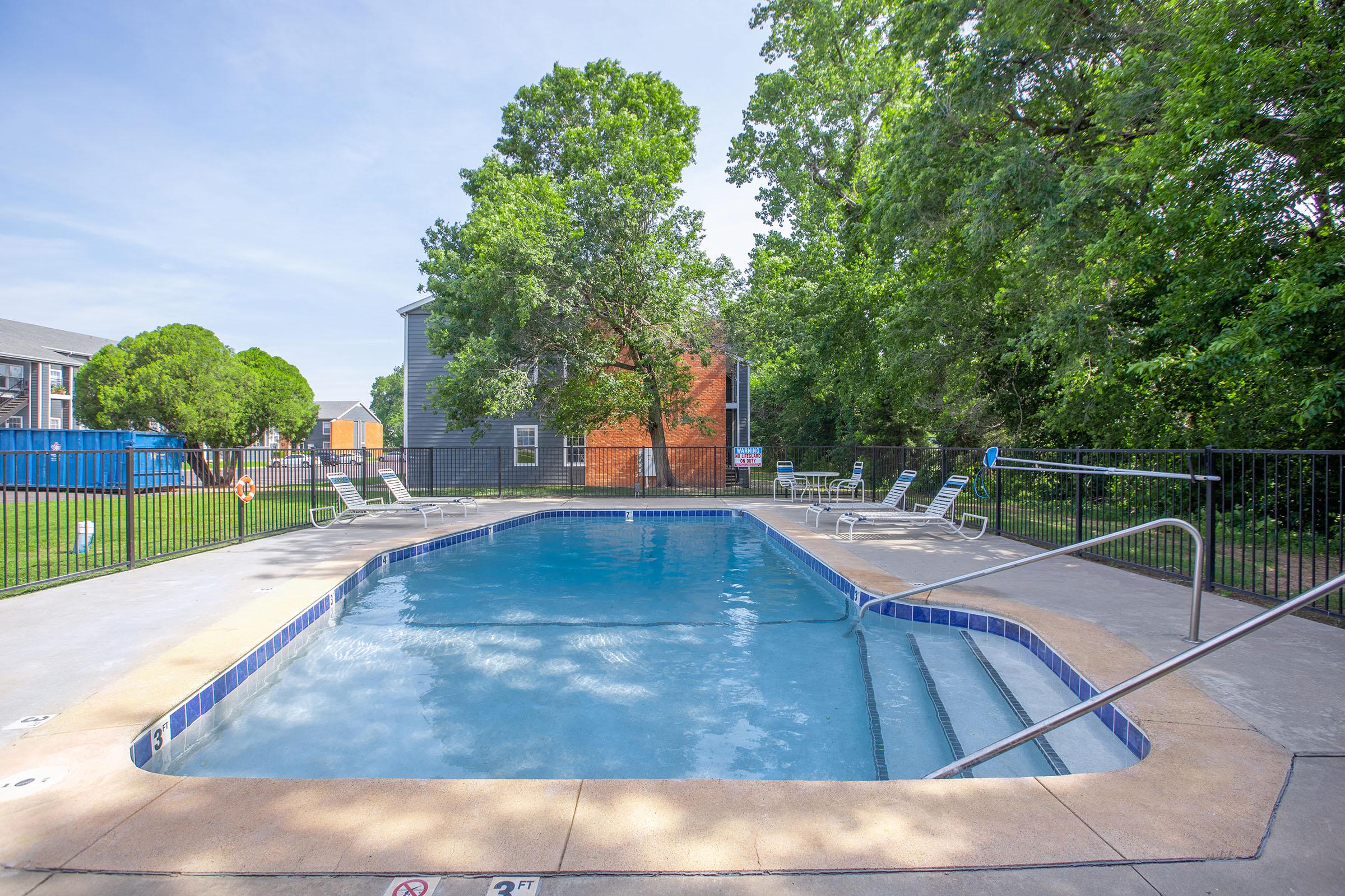 a pool next to a fence