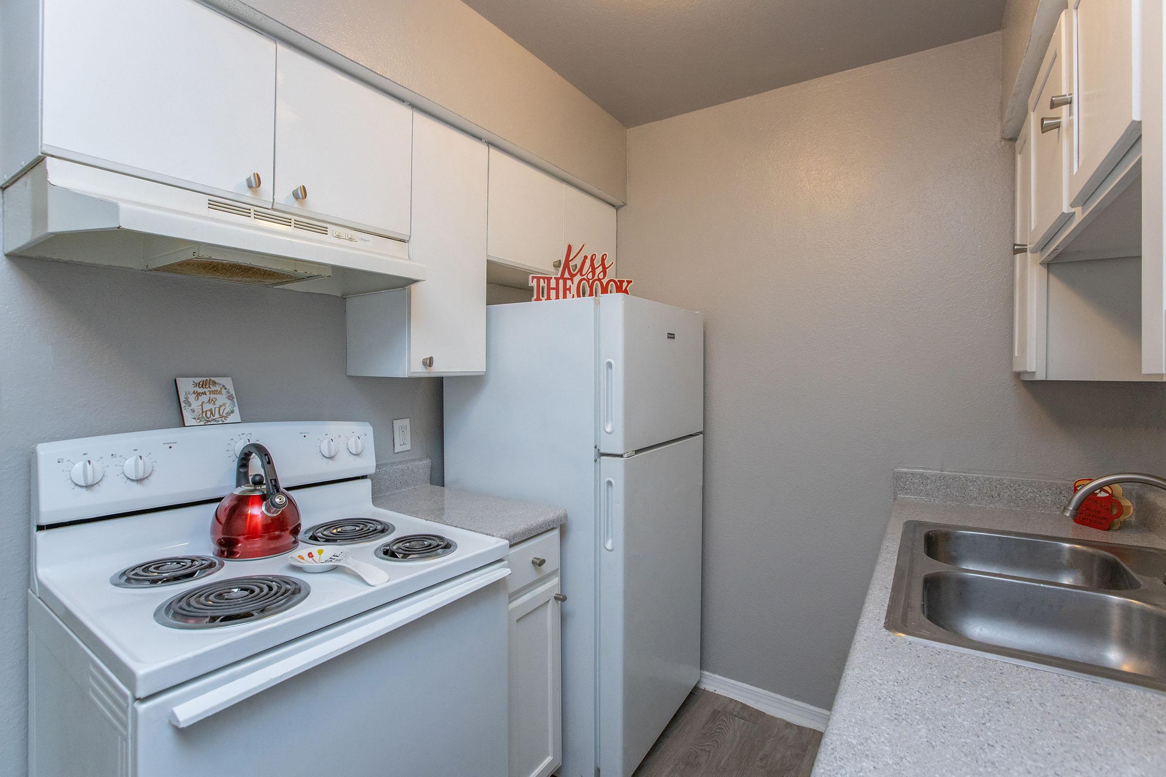 a kitchen with a stove top oven sitting inside of a refrigerator