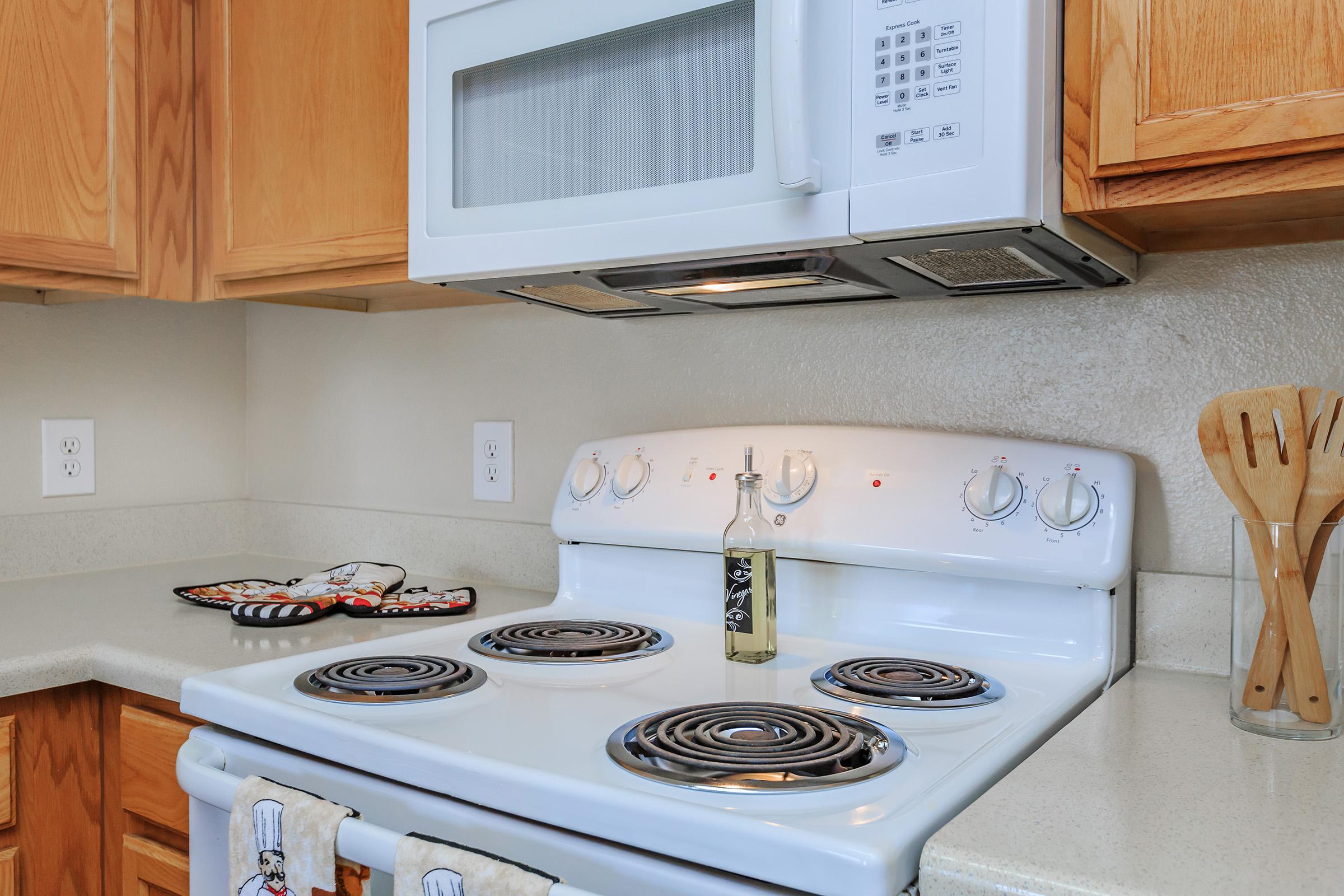 MICROWAVE AND PANTRY IN KITCHEN AT SOUTHPARK RANCH APARTMENTS
