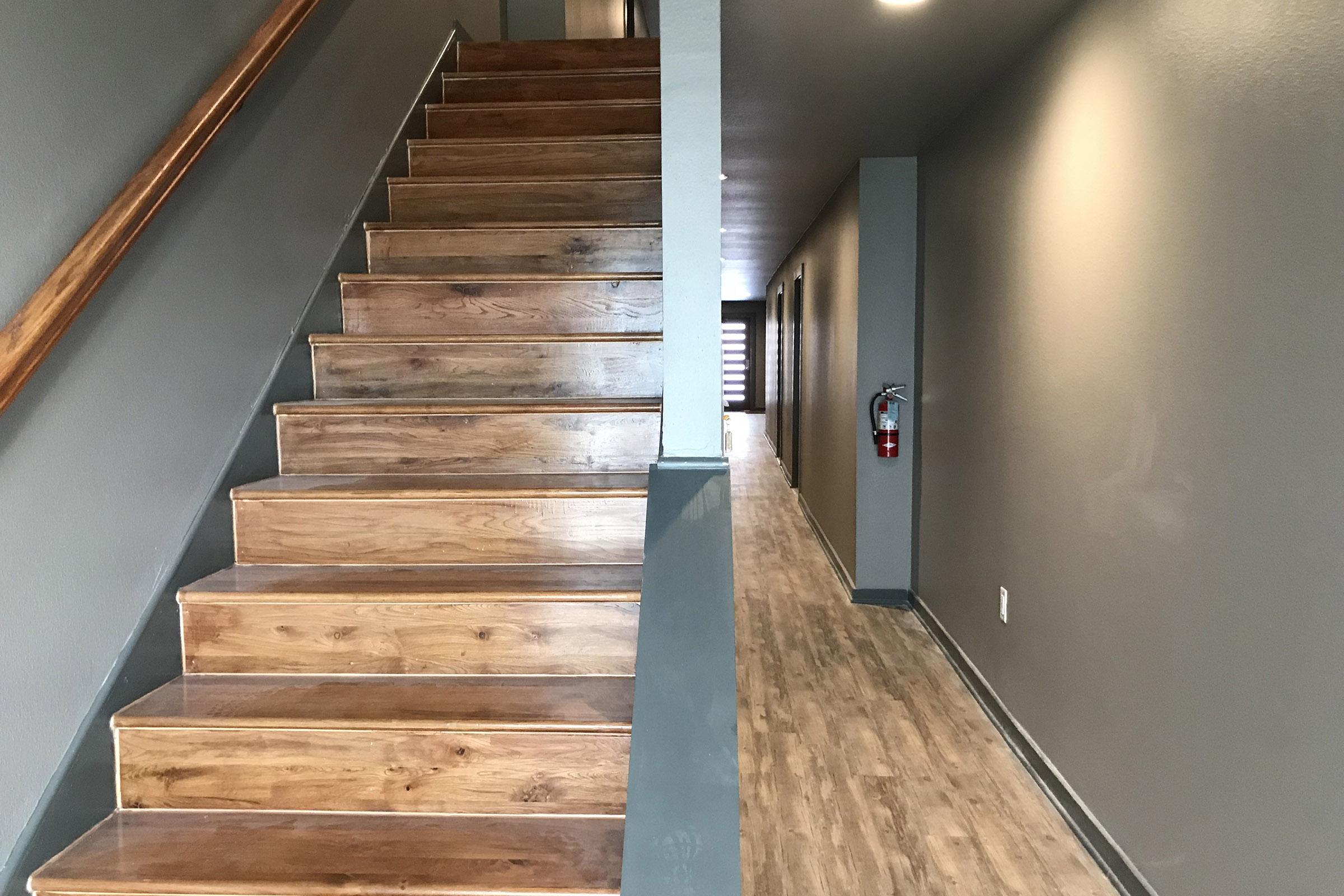 hallway and stairs with wooden floors
