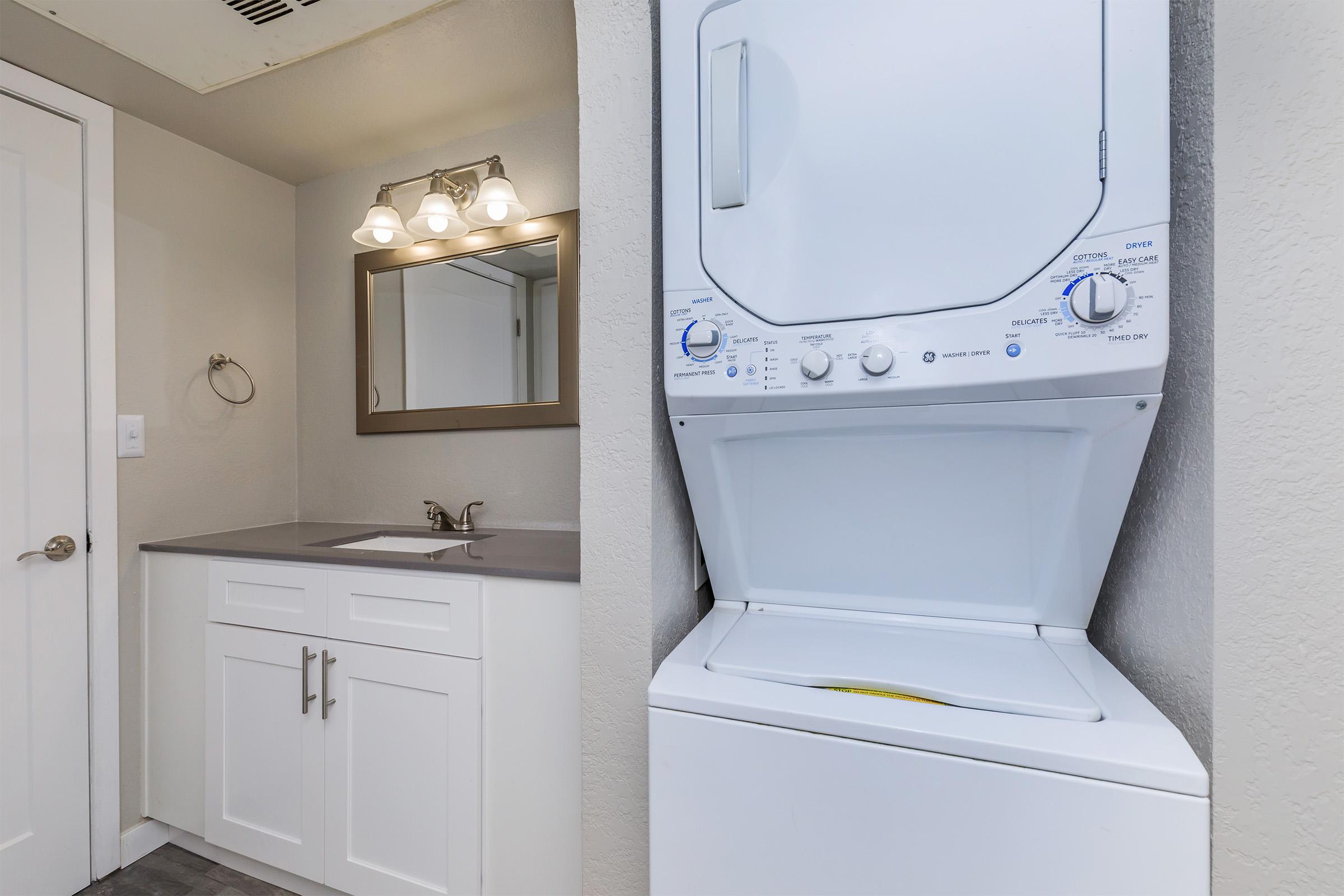 a white refrigerator freezer sitting next to a sink