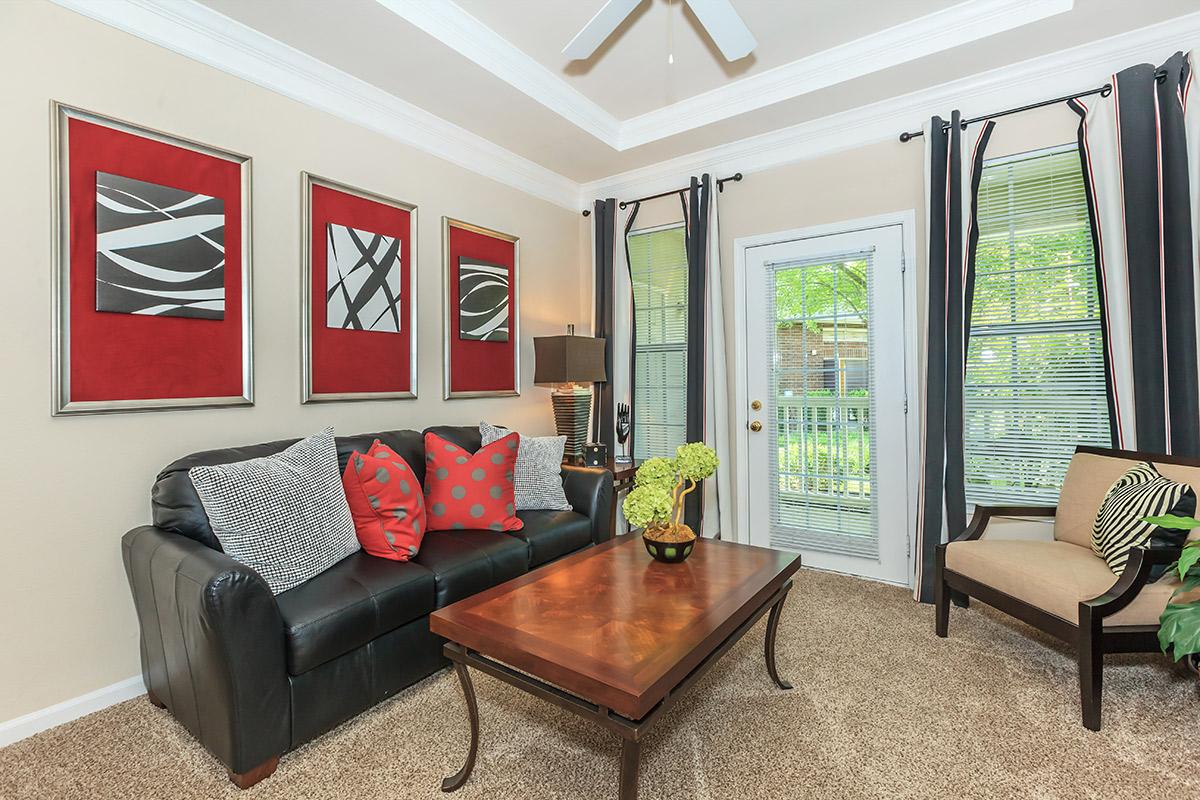 a living room filled with furniture and a large window