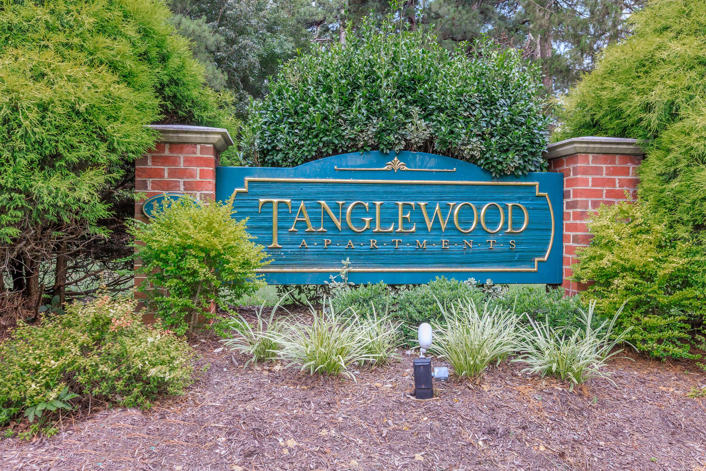 a blue sign sitting on the side of a house