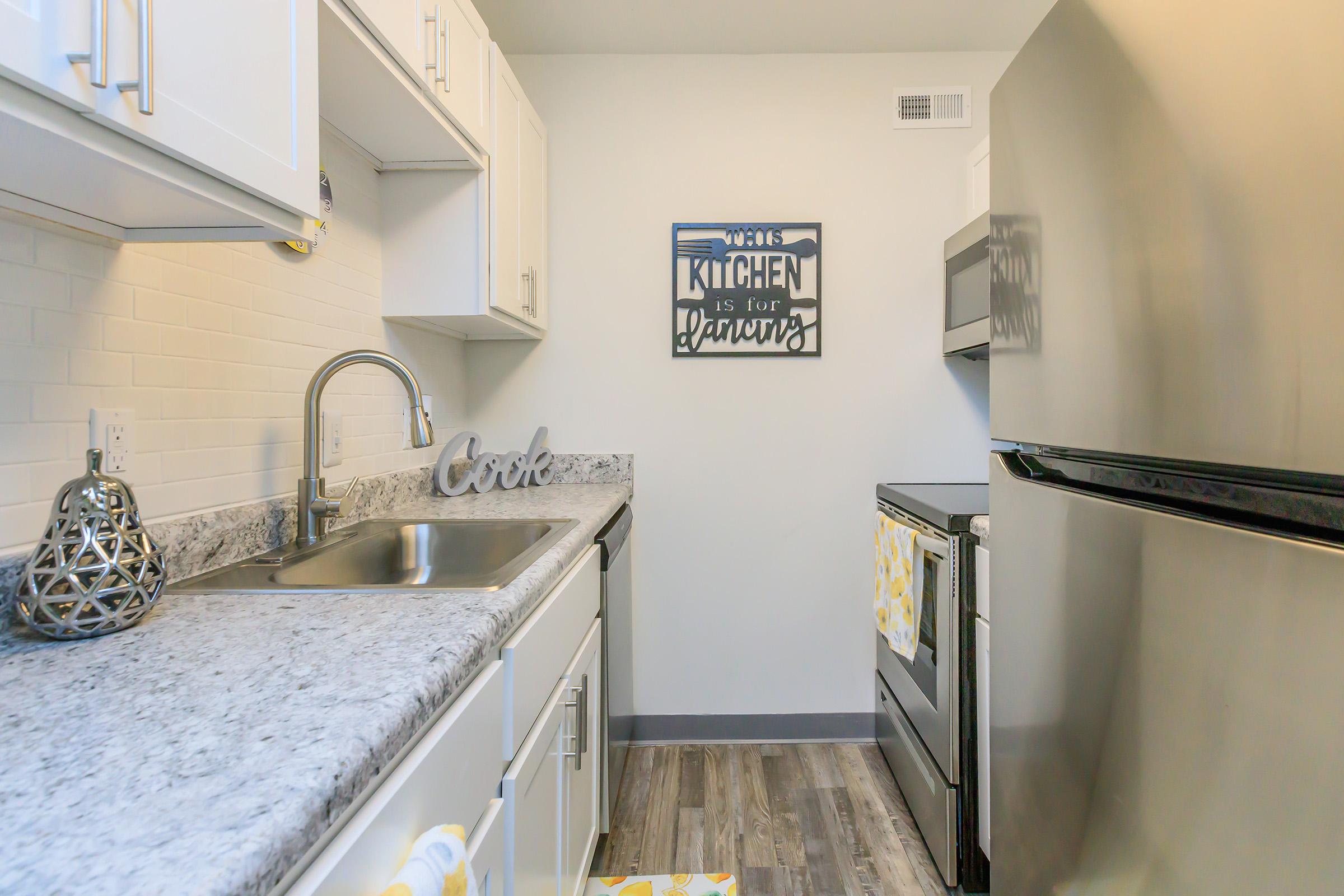 a kitchen with a stove sink and refrigerator