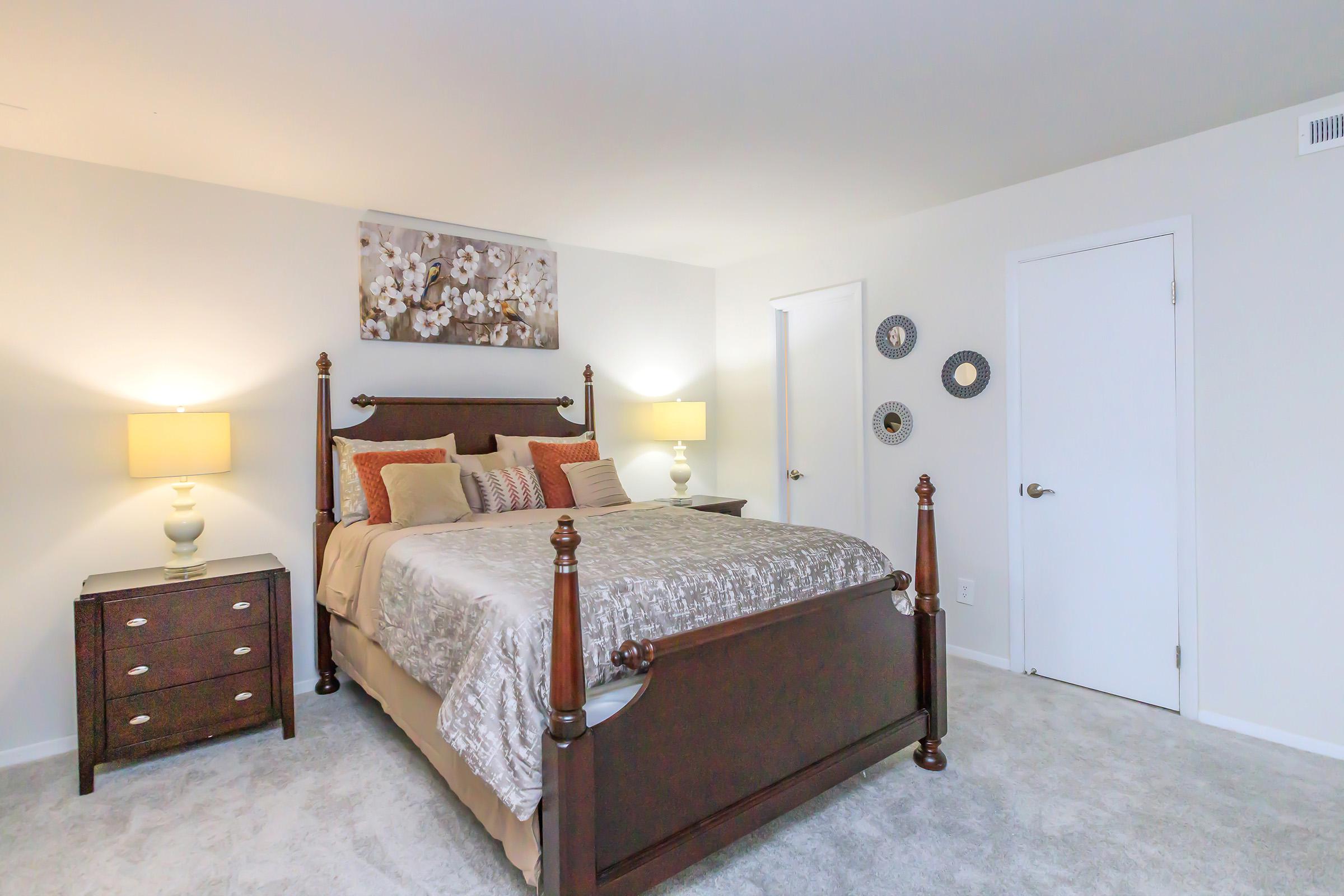 a bedroom with a bed and desk in a small room