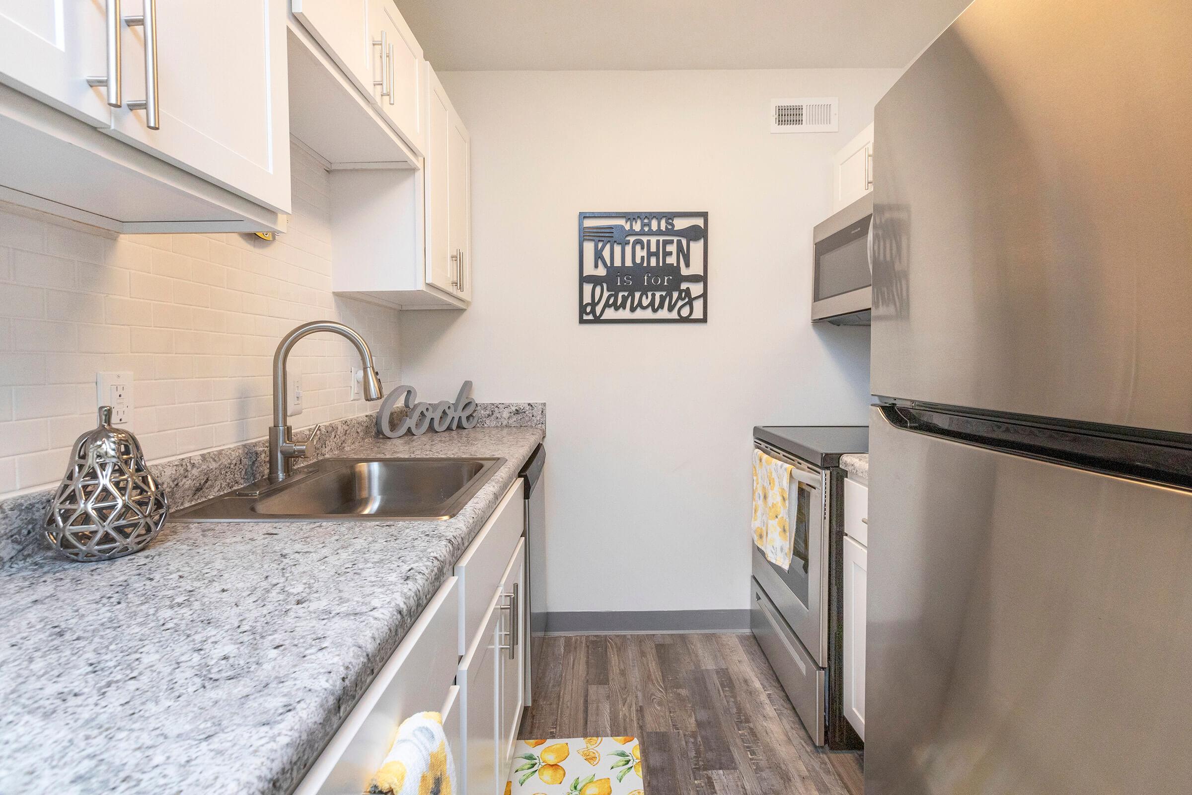 a kitchen with a sink and a mirror