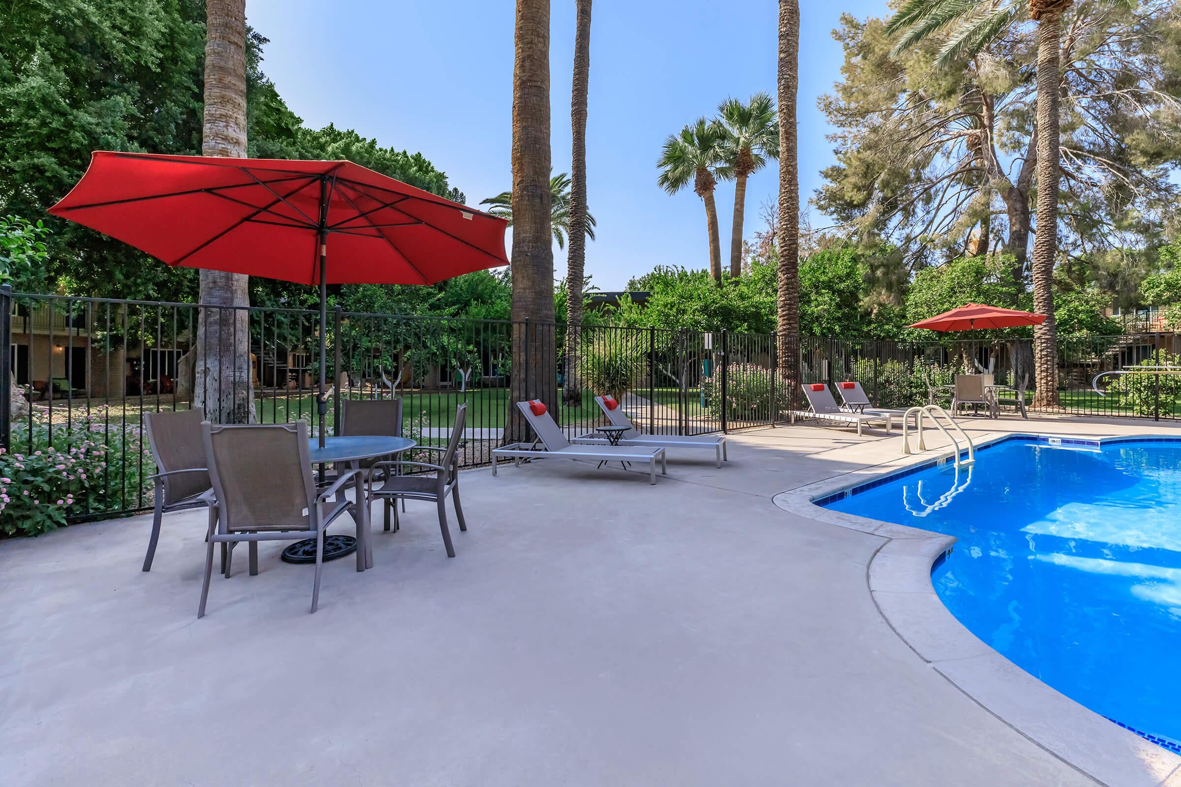 a group of lawn chairs sitting on top of a pool