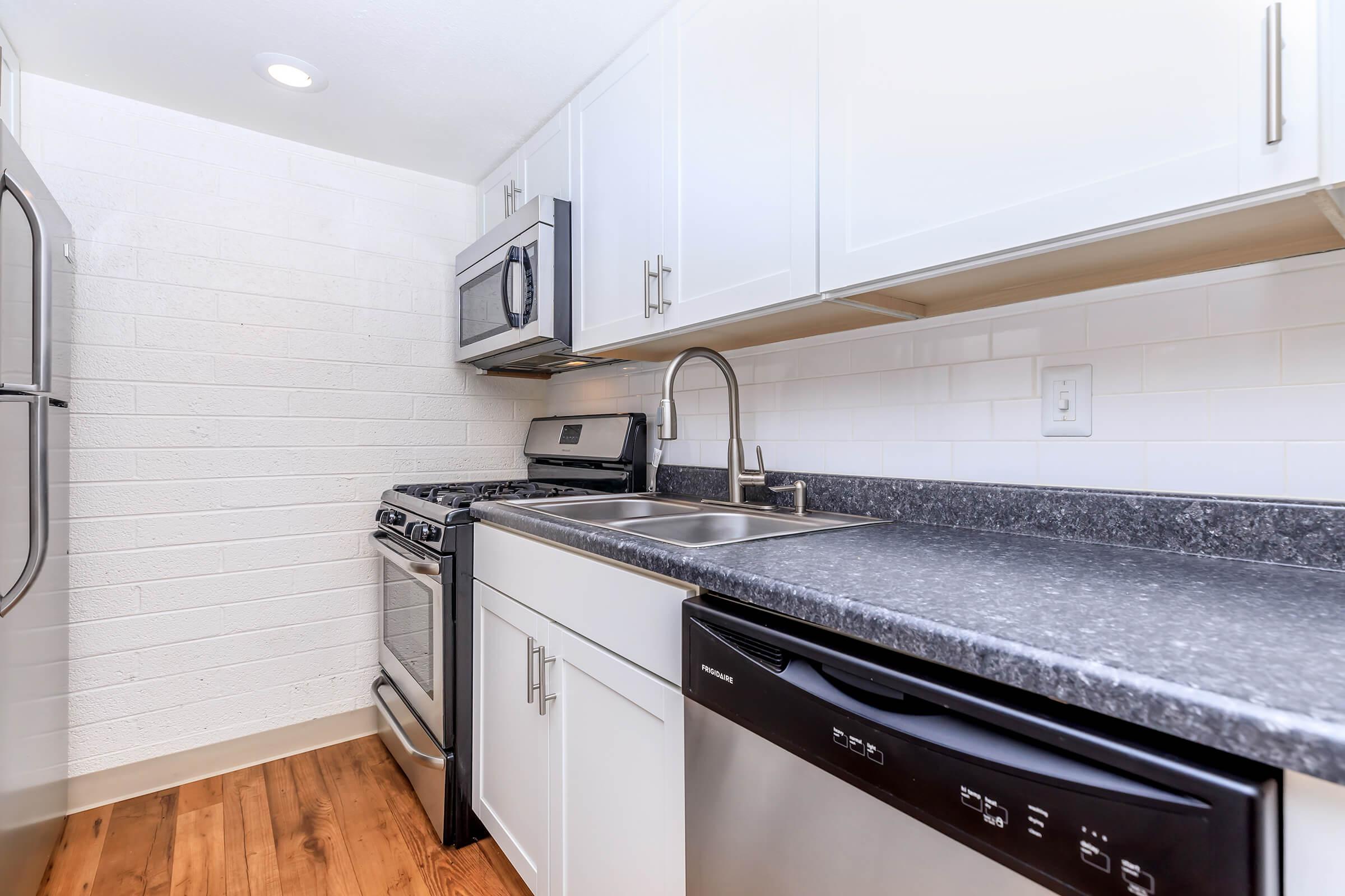 a stove top oven sitting inside of a kitchen