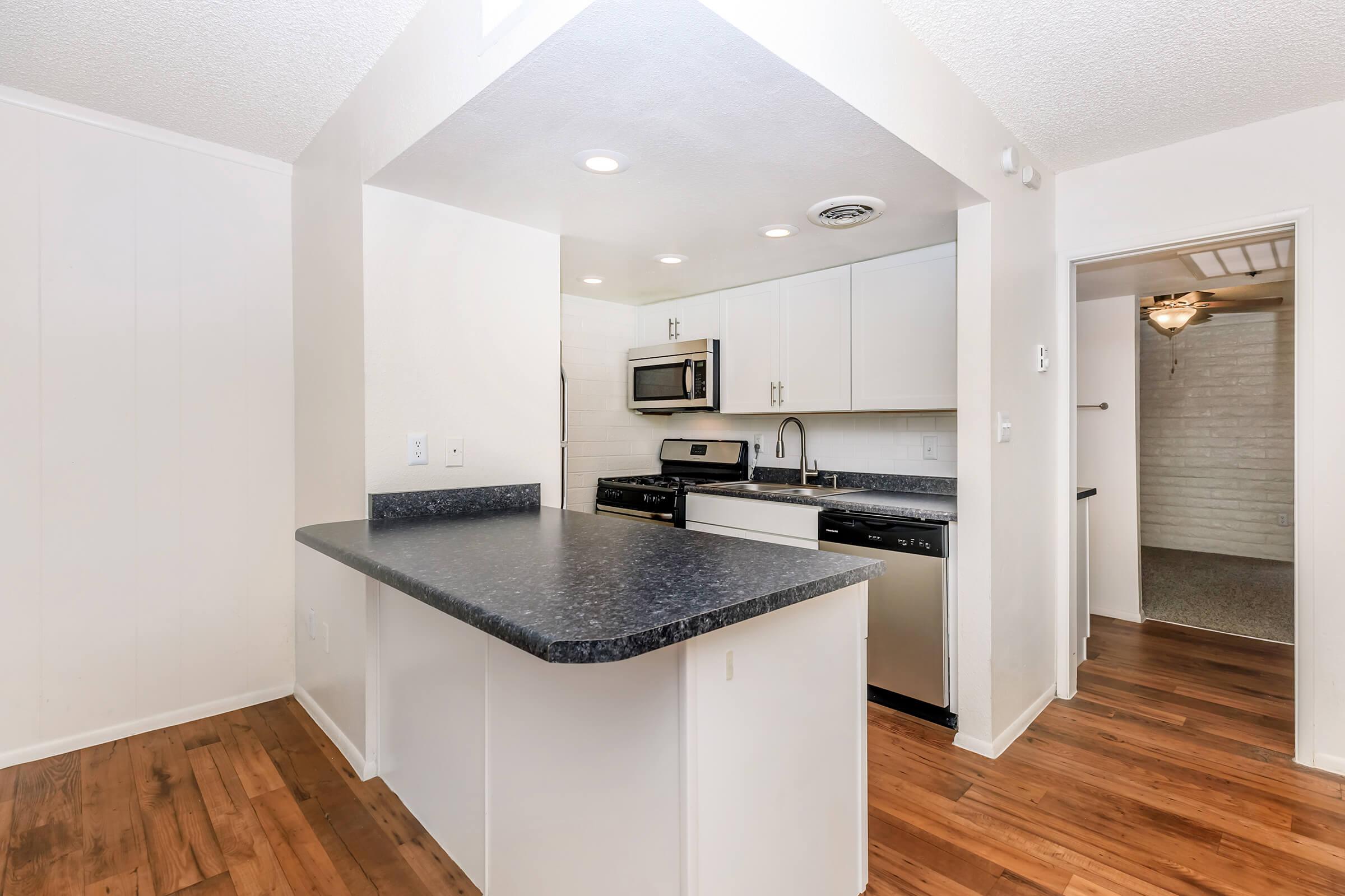 a kitchen with a wood floor