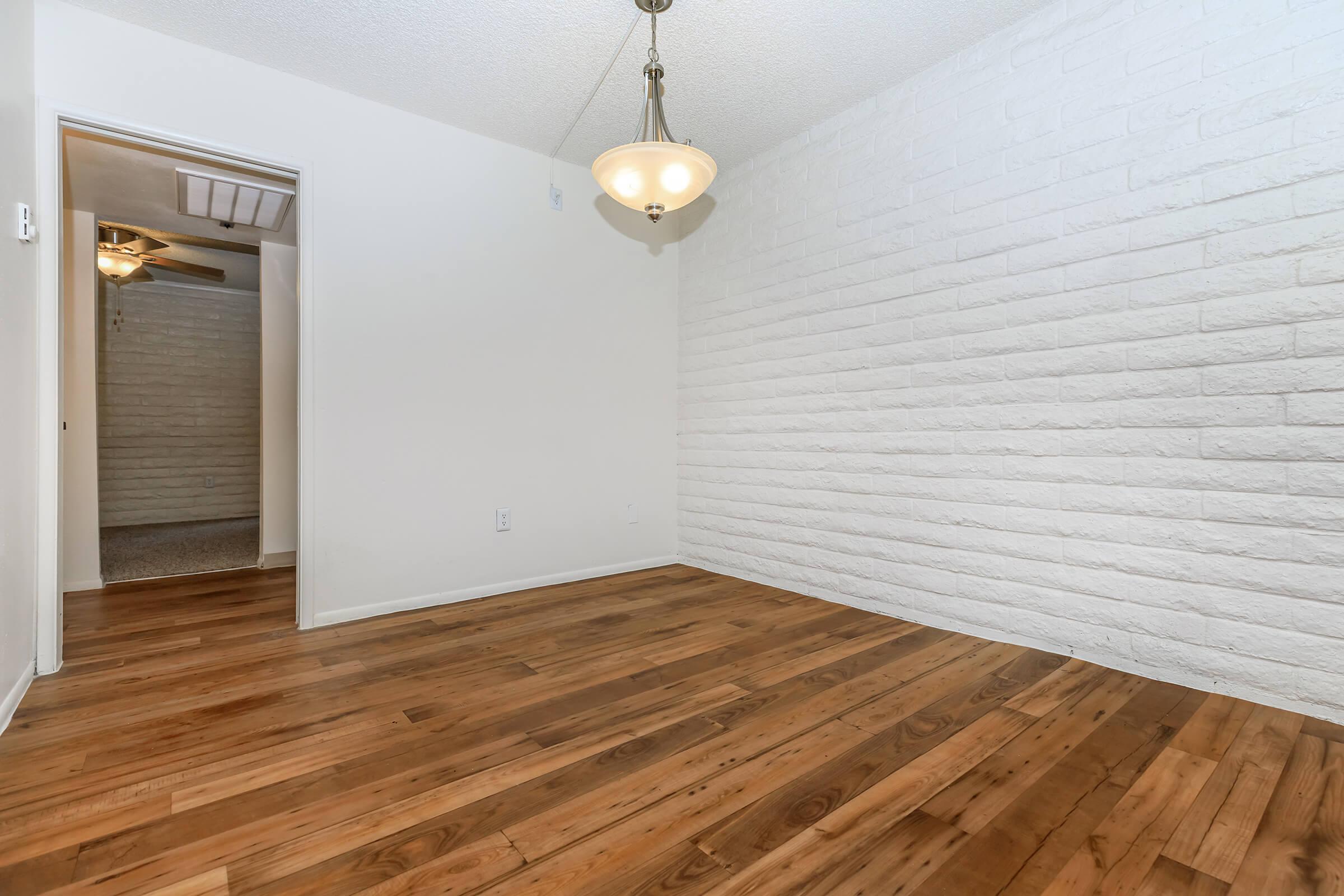 a bedroom with a wooden floor