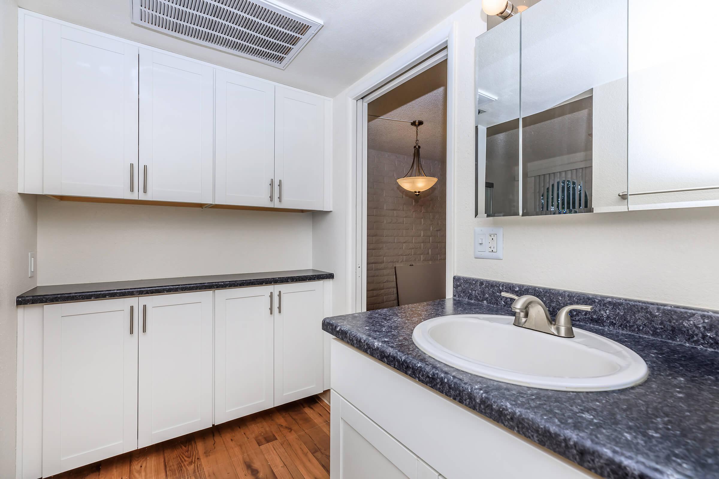 a kitchen with a sink and a mirror