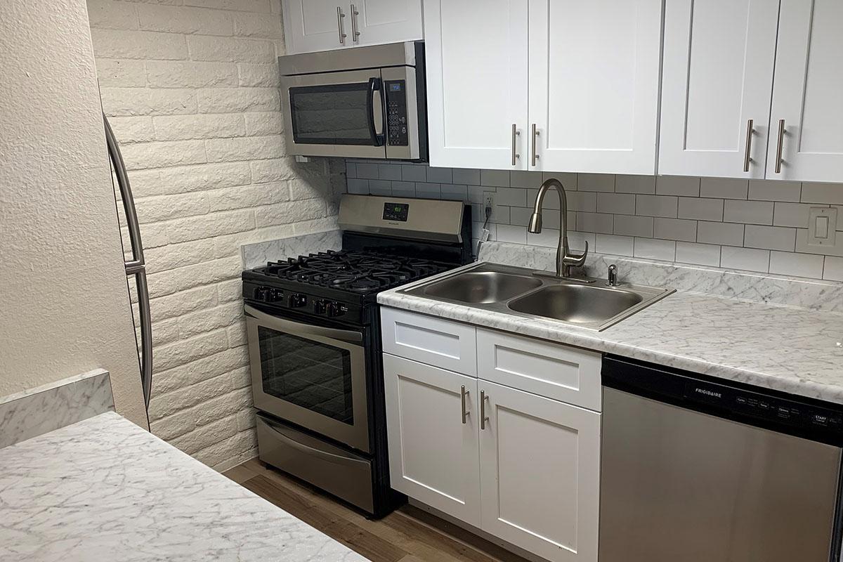 a kitchen with a stove and a sink