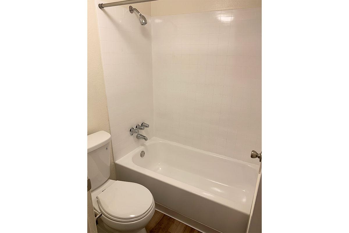 a white tub sitting next to a sink