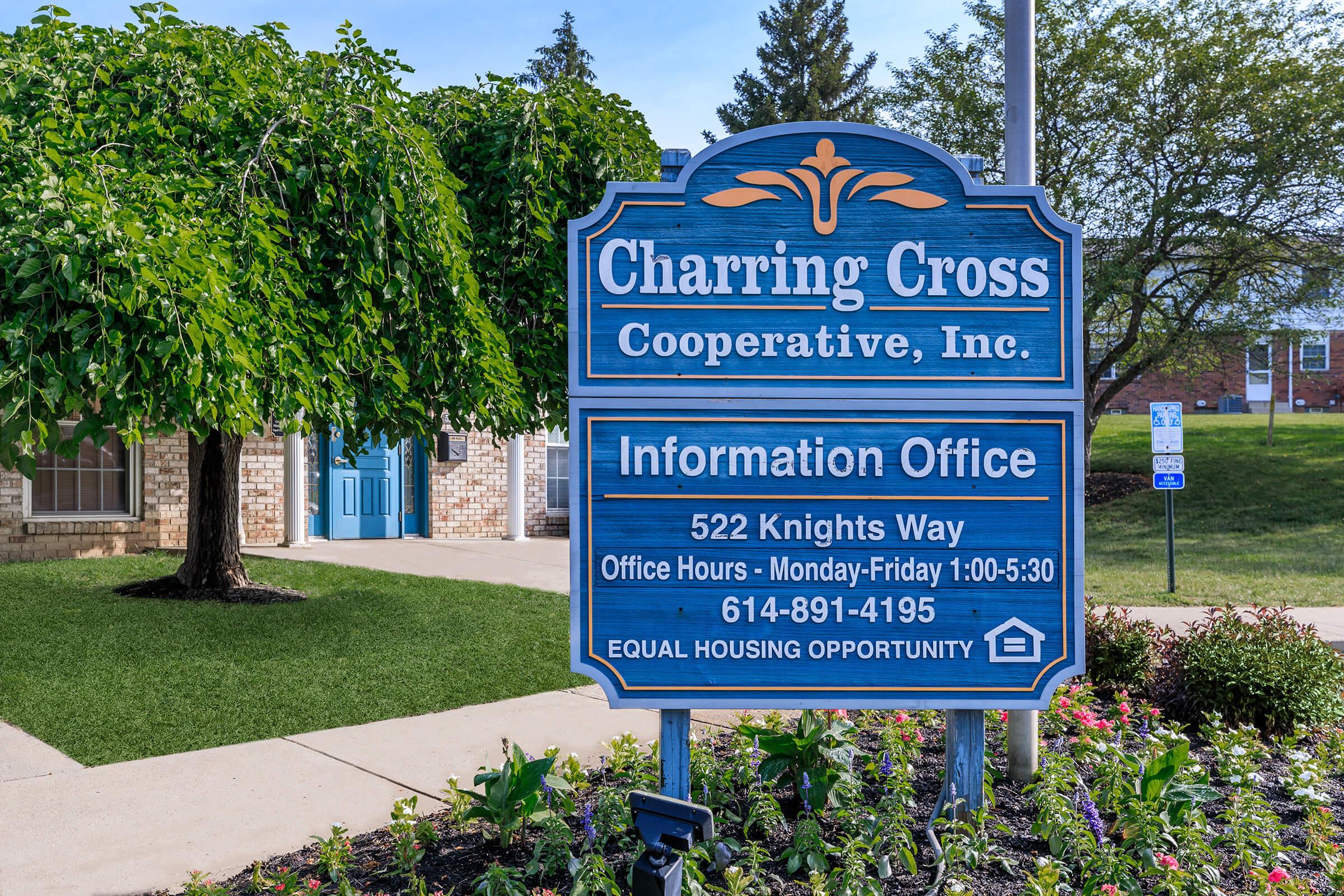 a blue sign sitting on the side of the street