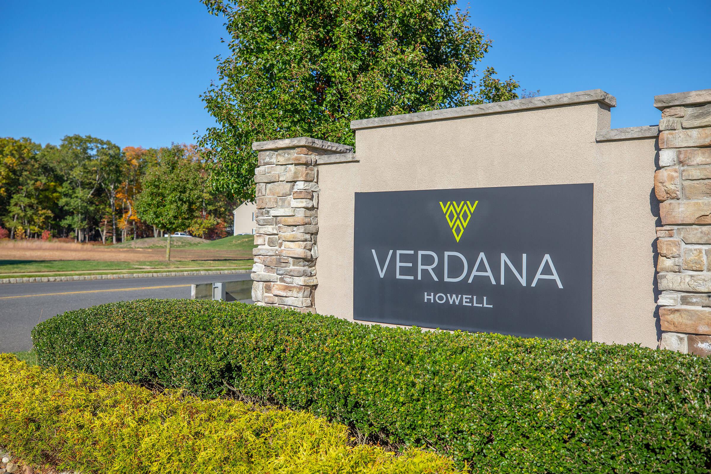 a sign in front of a brick building